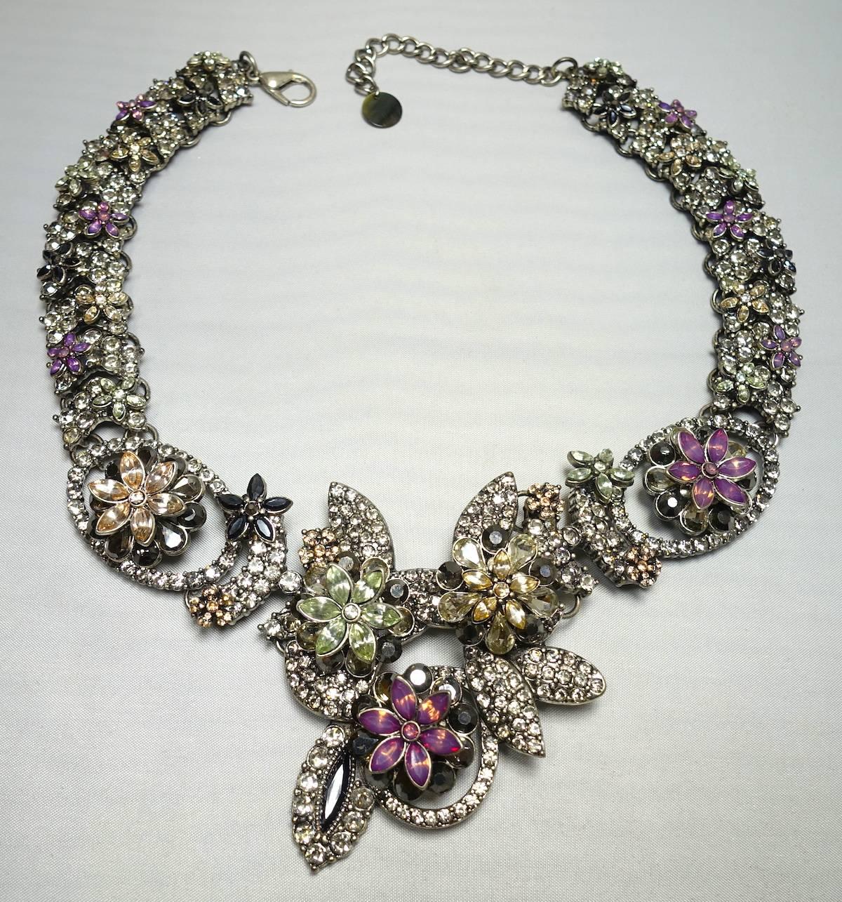 This gorgeous necklace features a 3-dimensional design with pink, peridot, gray & clear crystals in a silver tone setting.  This necklace measures 19” with a spring closure and the centerpiece is 3” x 2-1/4”. It is in excellent condition. 