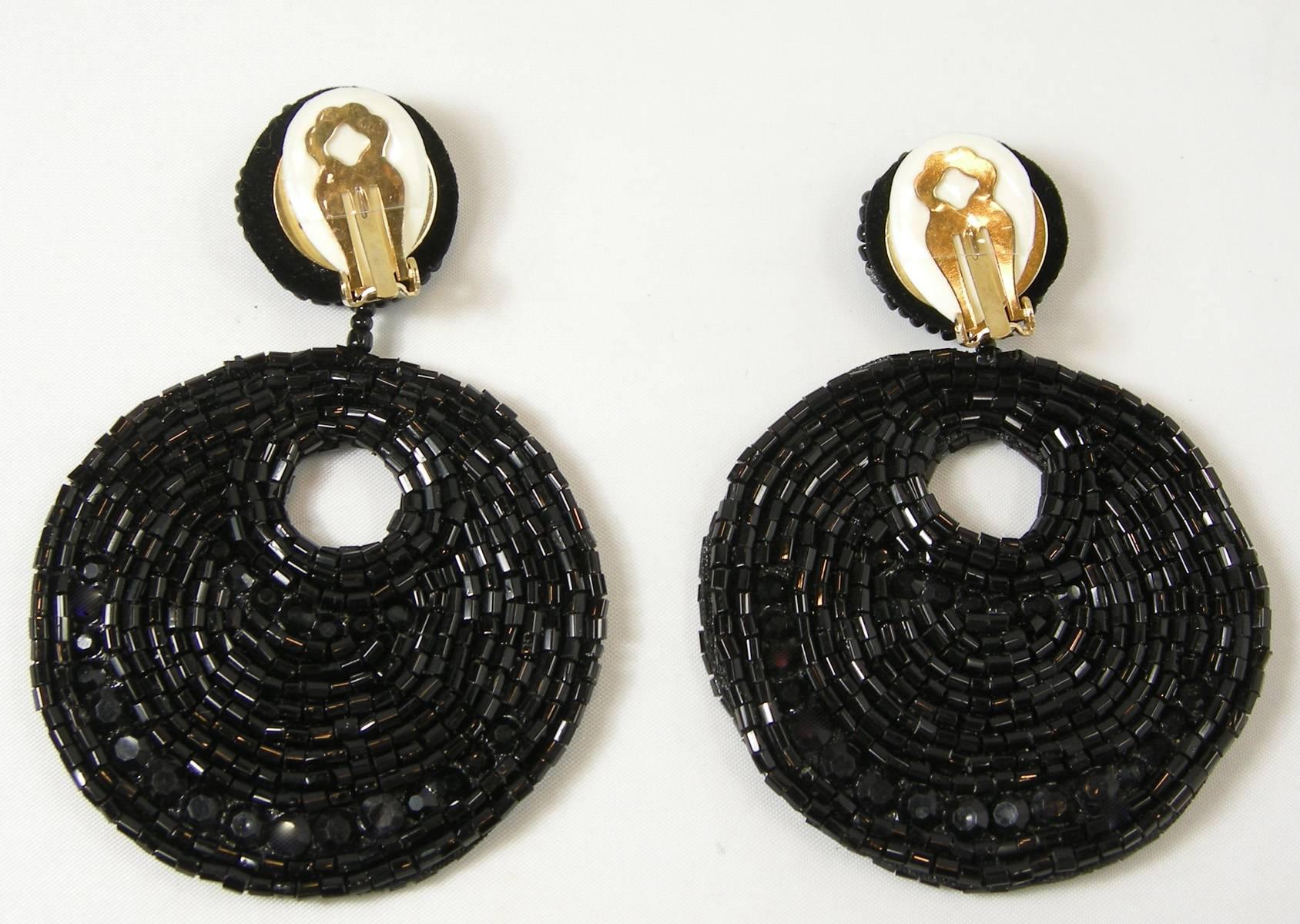 Here are Kenneth Jay Lane’s black beaded hoop earrings.  They are, again, perfect for any occasion at any time.  These clip earrings are made with white seed beads with the gypsy design hoops.  They measure 2-3/4” wide and 4-1/2” long.  They are