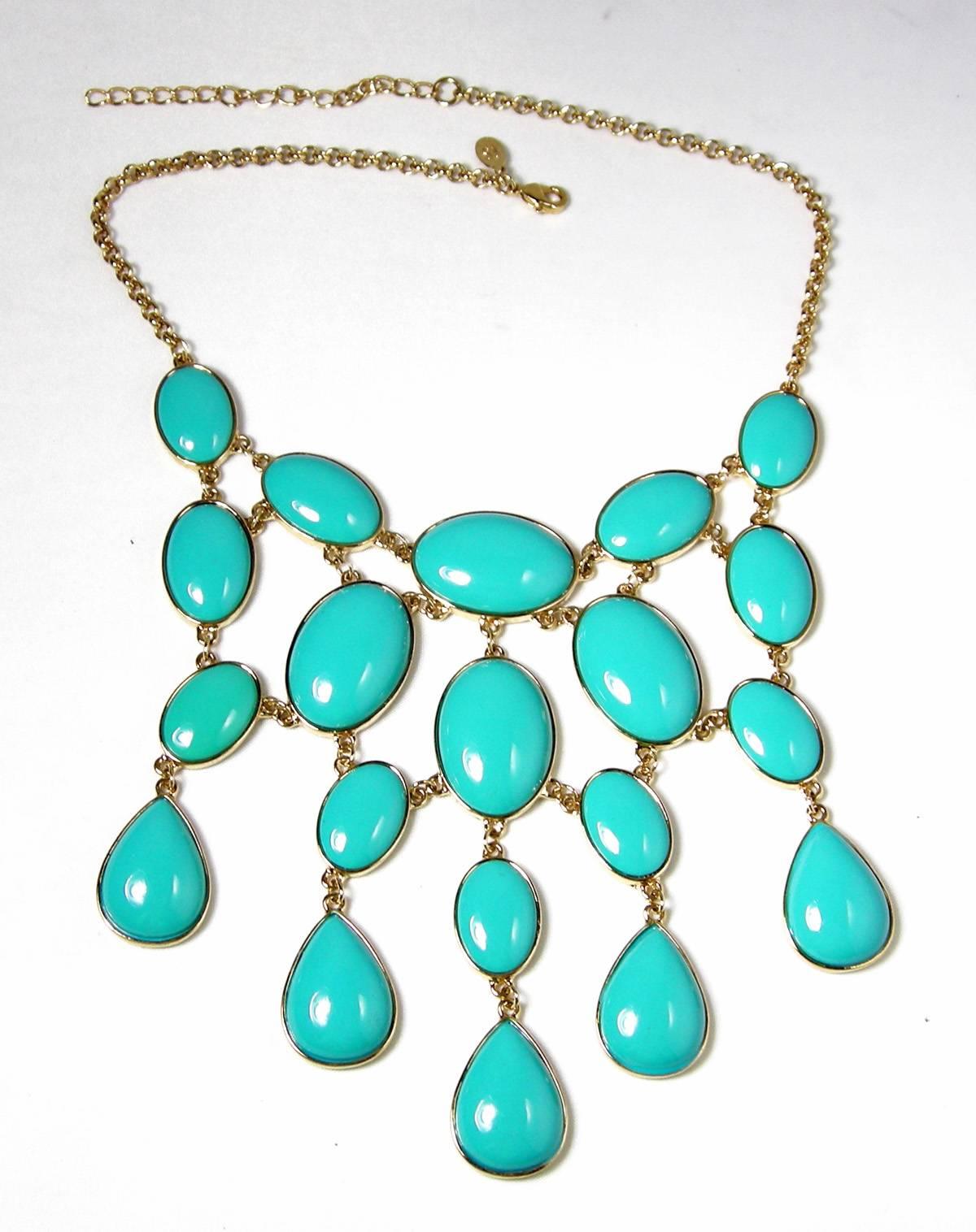 This a great Kenneth Jay Lane bib necklace has a gold tone rope chain leading to various oval and teardrop shaped faux turquoise stones.  It has a lobster clap and the necklaces measures 16” long.  The centerpiece is 5” wide and falls 4-3/4”.  It is