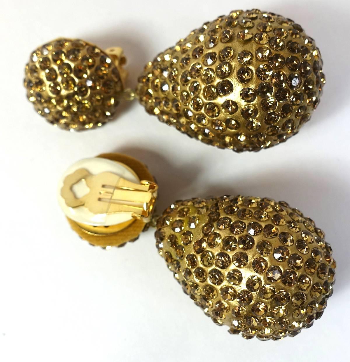 This signed Kenneth Jay Lane earrings feature gold tone crystals in a nickel-free gold-plated base metal setting.  These clip earrings measure 2-1/2” x 1-1/4” and are signed “Kenneth Lane”.  They are in excellent condition.
