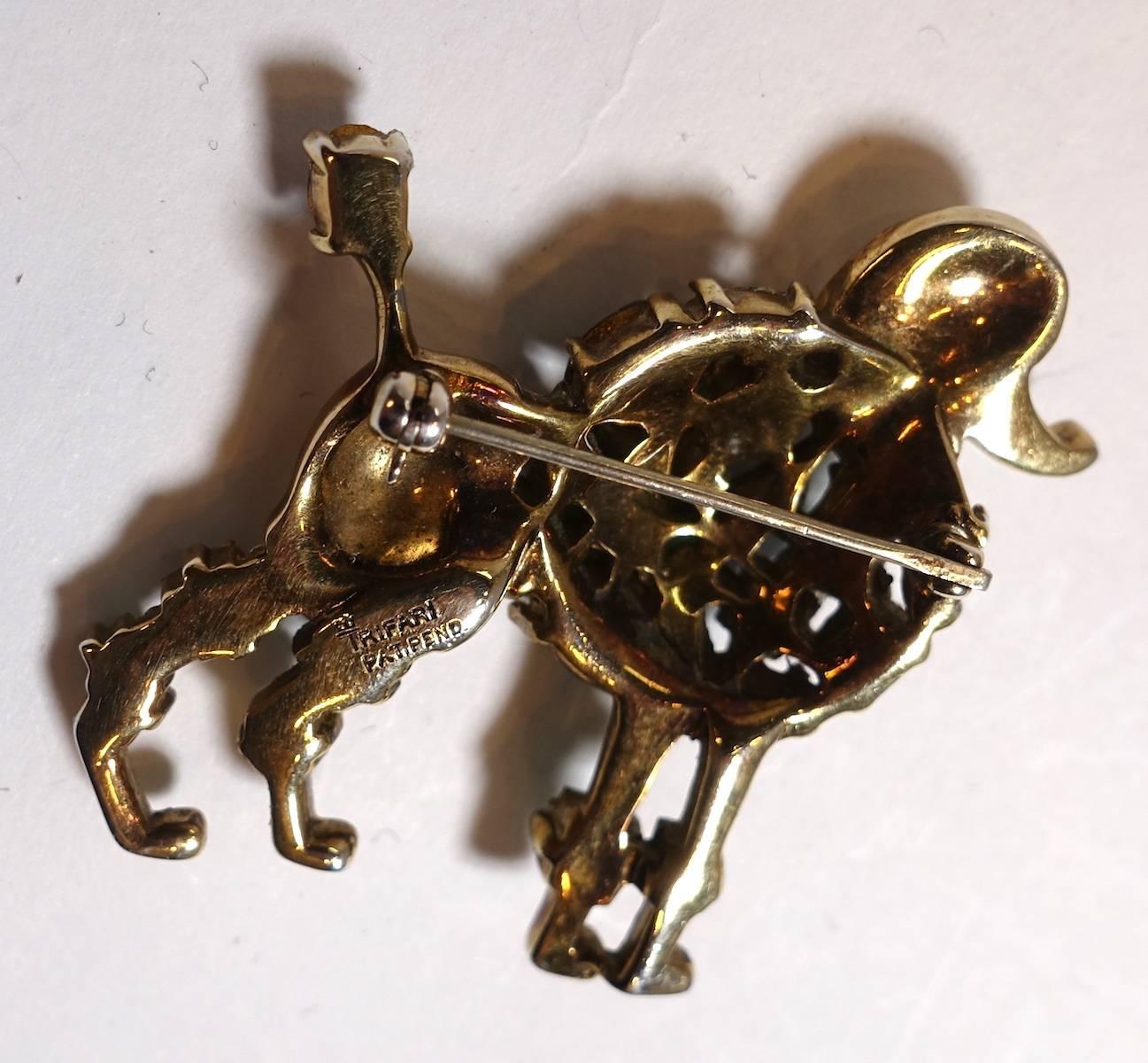 This famous vintage signed Trifari poodle brooch is designed multi-color crystals in sterling silver with a gold vermeil setting.  This brooch measures 1-3/4” x 1-3/4” and is signed with the crown over the T… “Trifari Sterling”.  It is in excellent