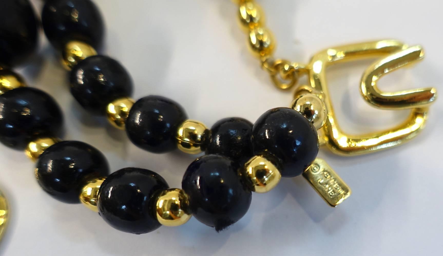 This signed Kenneth Lane necklace features black beads with twisted black twine around each bead.  In excellent condition, this necklace measures 16” and the center falls 4-1/2”.  It has a hook closure and is signed “Kenneth Lane”.  It is in