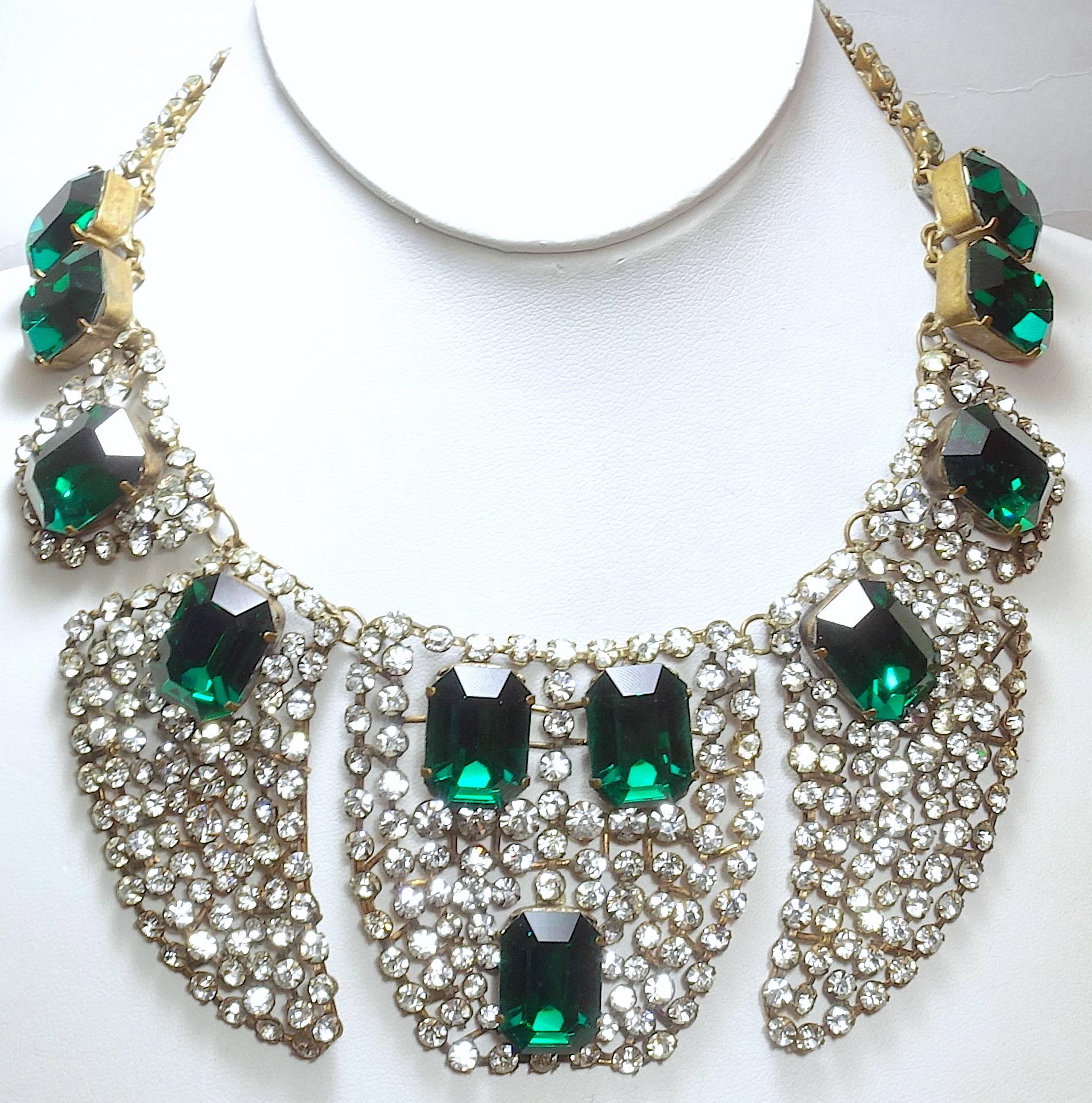 This is an amazing necklace from the early 1920s/30s. It has French paste throughout with emerald shaped green glass … all pronged set.  It is 16”.  The centerpiece has 3 segments and measures 5-1/2” wide and 2-1/2” long.  It is made with antique
