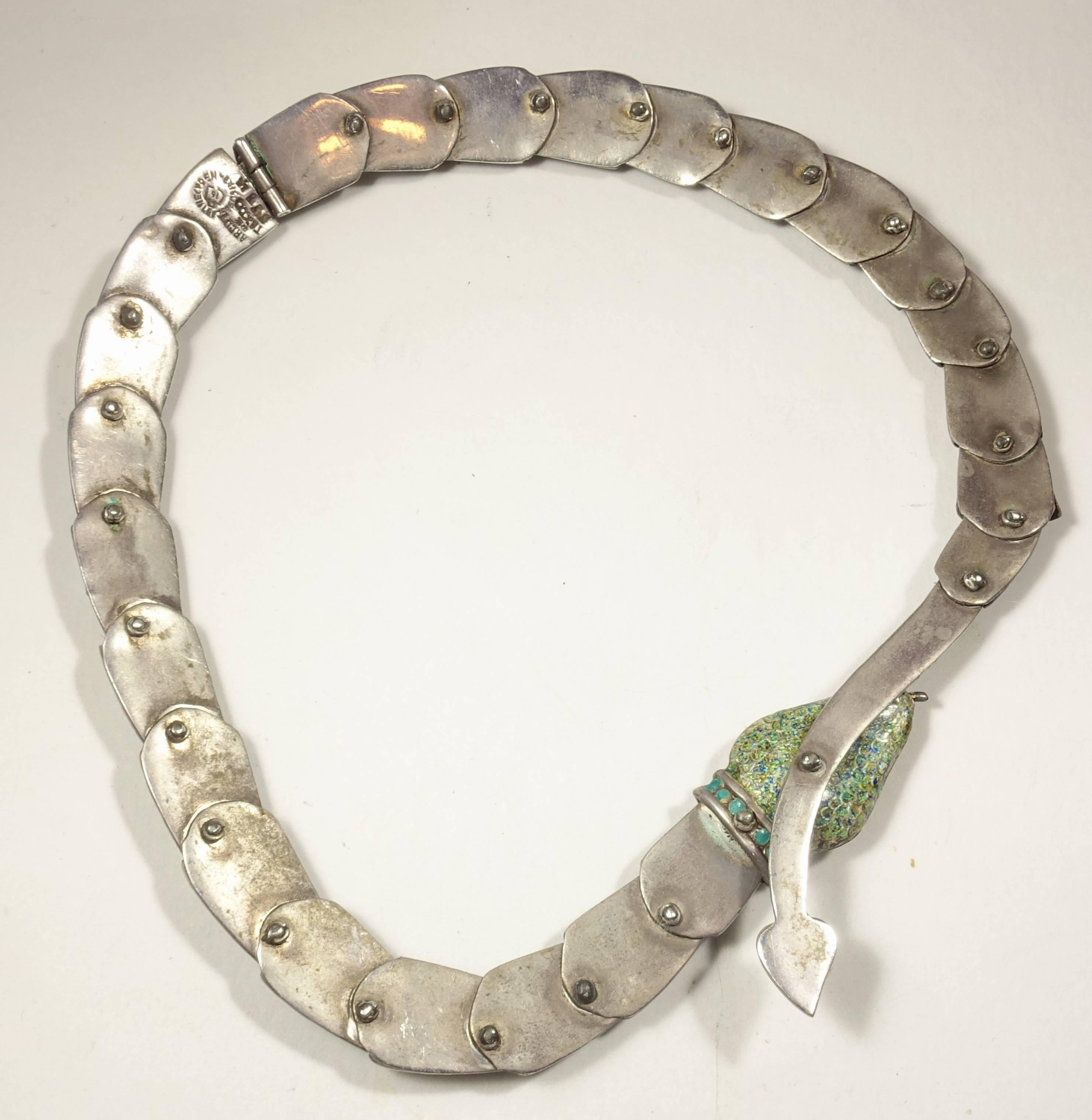 This has to be one of the most amazing vintage Margot necklaces I have ever seen.  It is made of sterling silver with green speckled enamel movable scales throughout its body.  Each scale is accentuated with a green stone. It has a slide in clasp. 