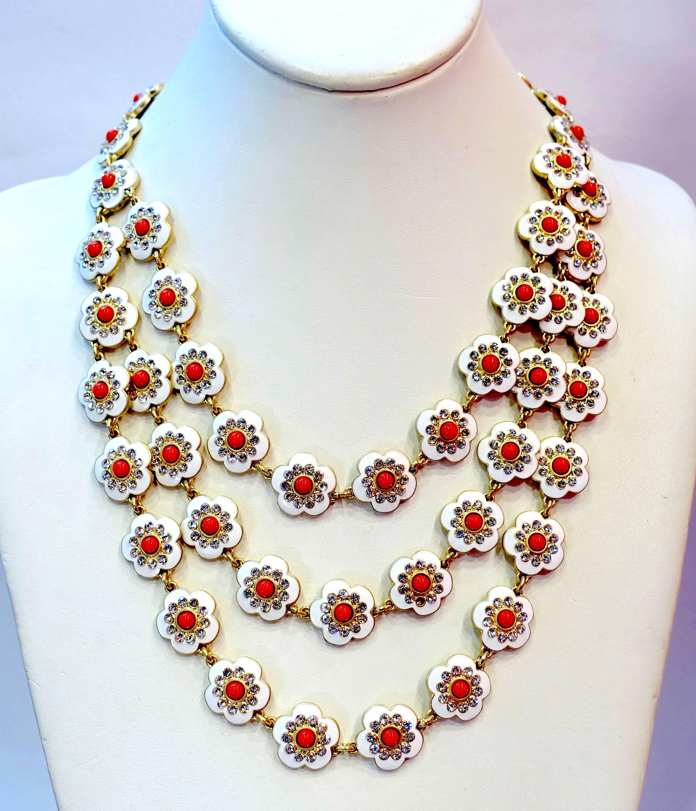 I fell in love with this necklace the instant I saw it and to find out it was made by Oscar de la Renta was an extra bonus.  The entire necklace has 3 rows of flowers that are white enamel with crystals surrounding a red center stone.  The top row