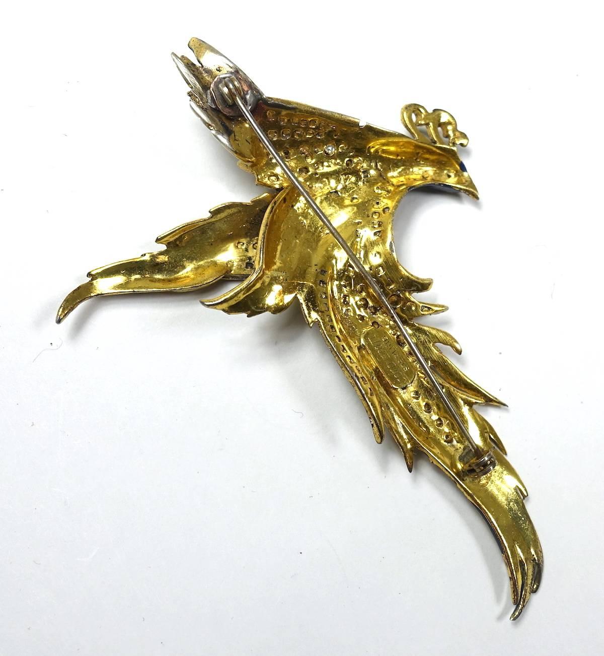 This vintage 1940s signed CoroCraft brooch features a bird with multi-color enameling and clear crystals throughout its body and wings. It’s in sterling silver with a gold vermeil setting.  This brooch measures 4” x 3” and is signed “CoroCraft