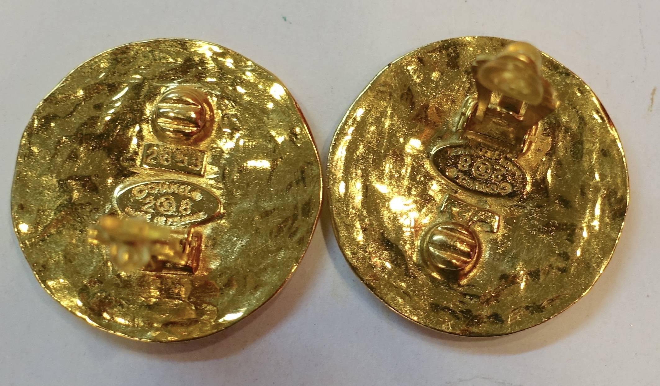 These vintage Chanel earrings are from season 28.  They are large round clips with the double Cs in the middle and Chanel Paris on the border.  They measure 1-1/2” and signed “Chanel 28 Made in France”.  They are in excellent condition.