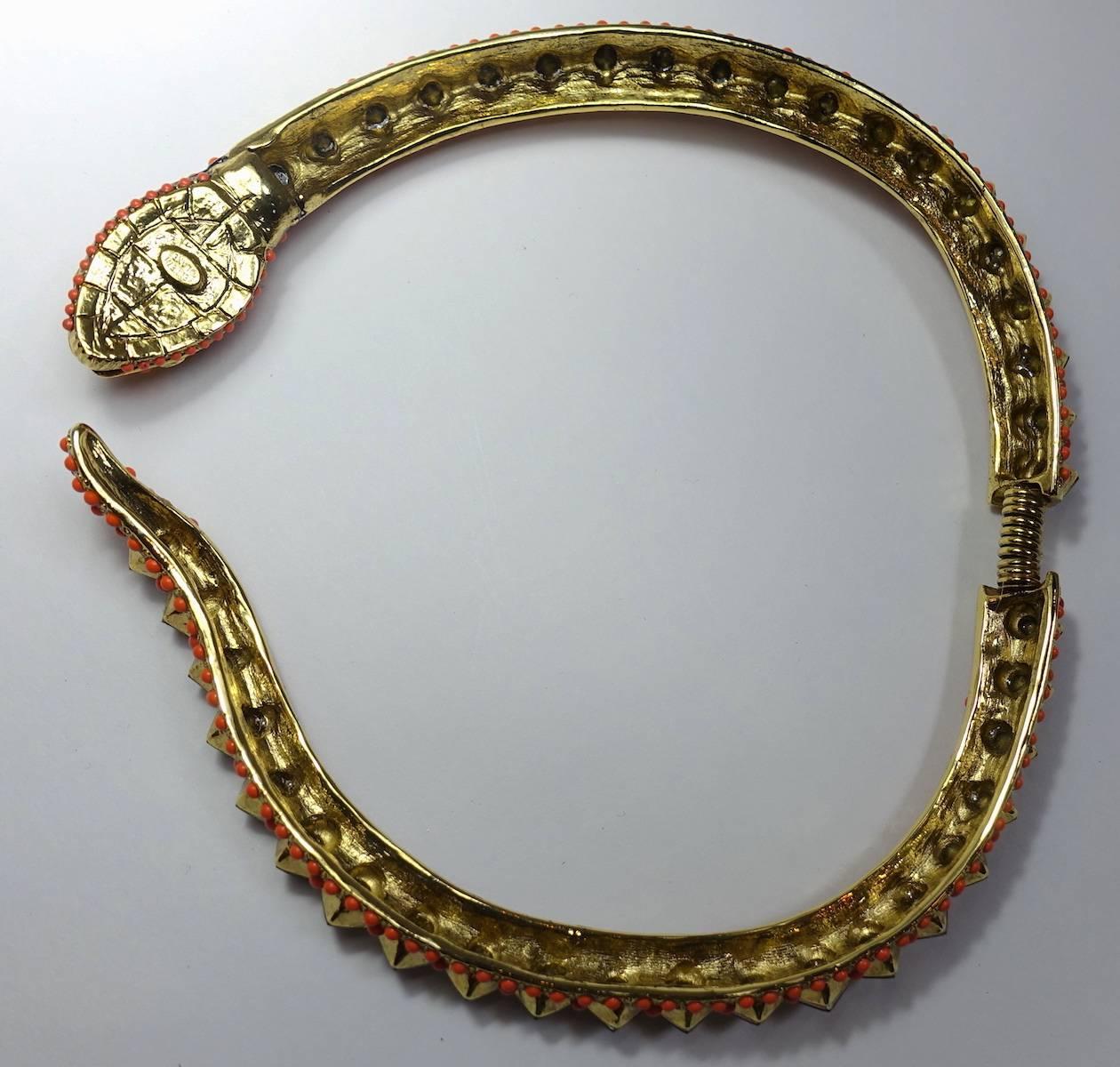 This signed Kenneth Lane necklace features a snake design with hues of topaz crystals in a nickel-free japanned silver-plated base metal setting.  This necklace measures 16” with a flexible-spring-back for easy fit.  It is signed “Kenneth Lane” and