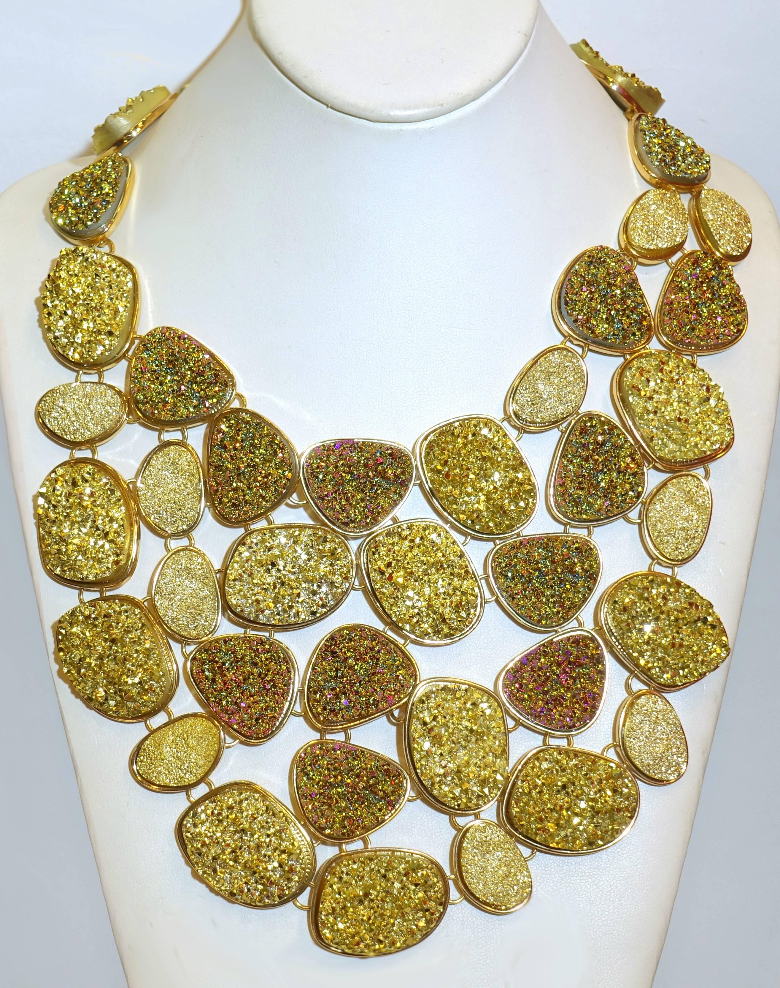 This is one of the one most unusual Oscar de la Renta’s necklaces I have even seen.  It is created with different shades of green, iridescent pink and beige crystallized stones in various shaped disks designed in an extravagant bib necklace.  Each