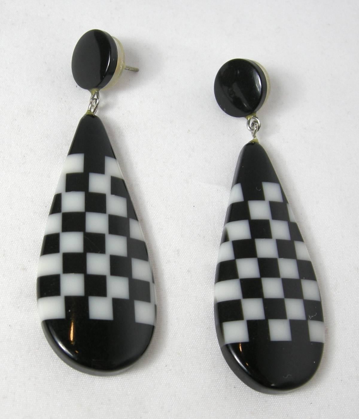 These pierced earrings are so cool and definitely from the 80s . They are black with a black and white checkerboard design in the middle.  They measure 3” long and 7/8” wide.  They are in excellent condition.