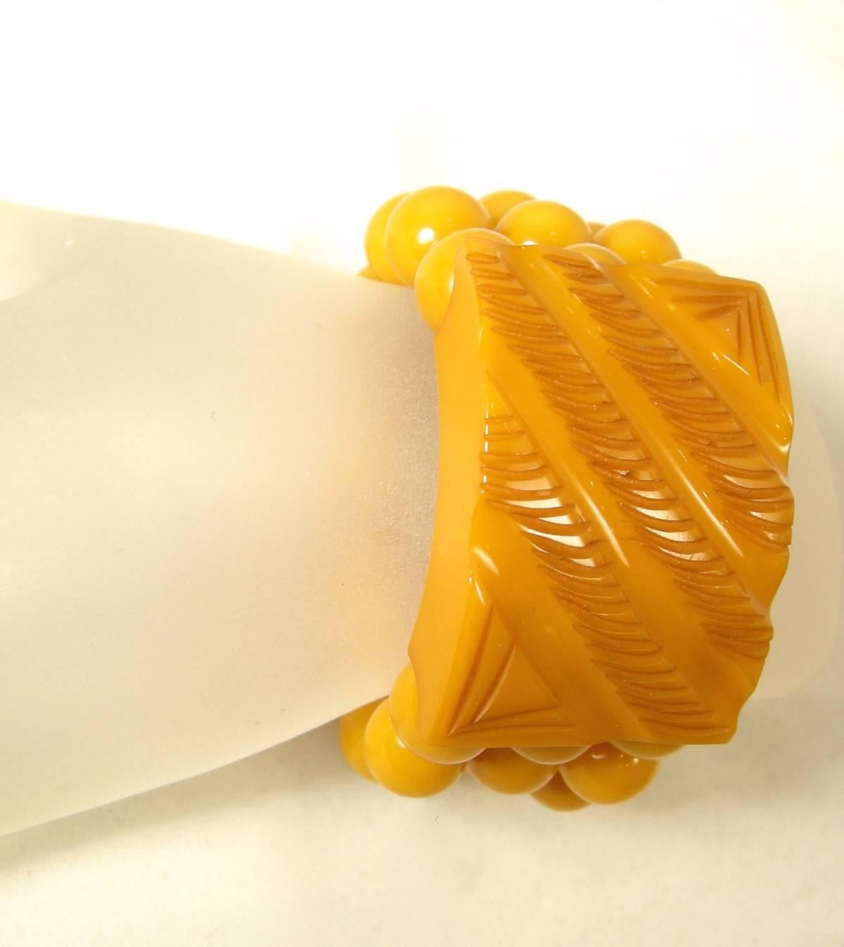 I love butterscotch Bakelite and this is no exception.  It has 3 rows of Bakelite beads leading to the carved rectangular center.  The center is 1-1/2” x 2”.   The Bakelite beads are connected to stretch.  It will fit a size 5-6 size wrist