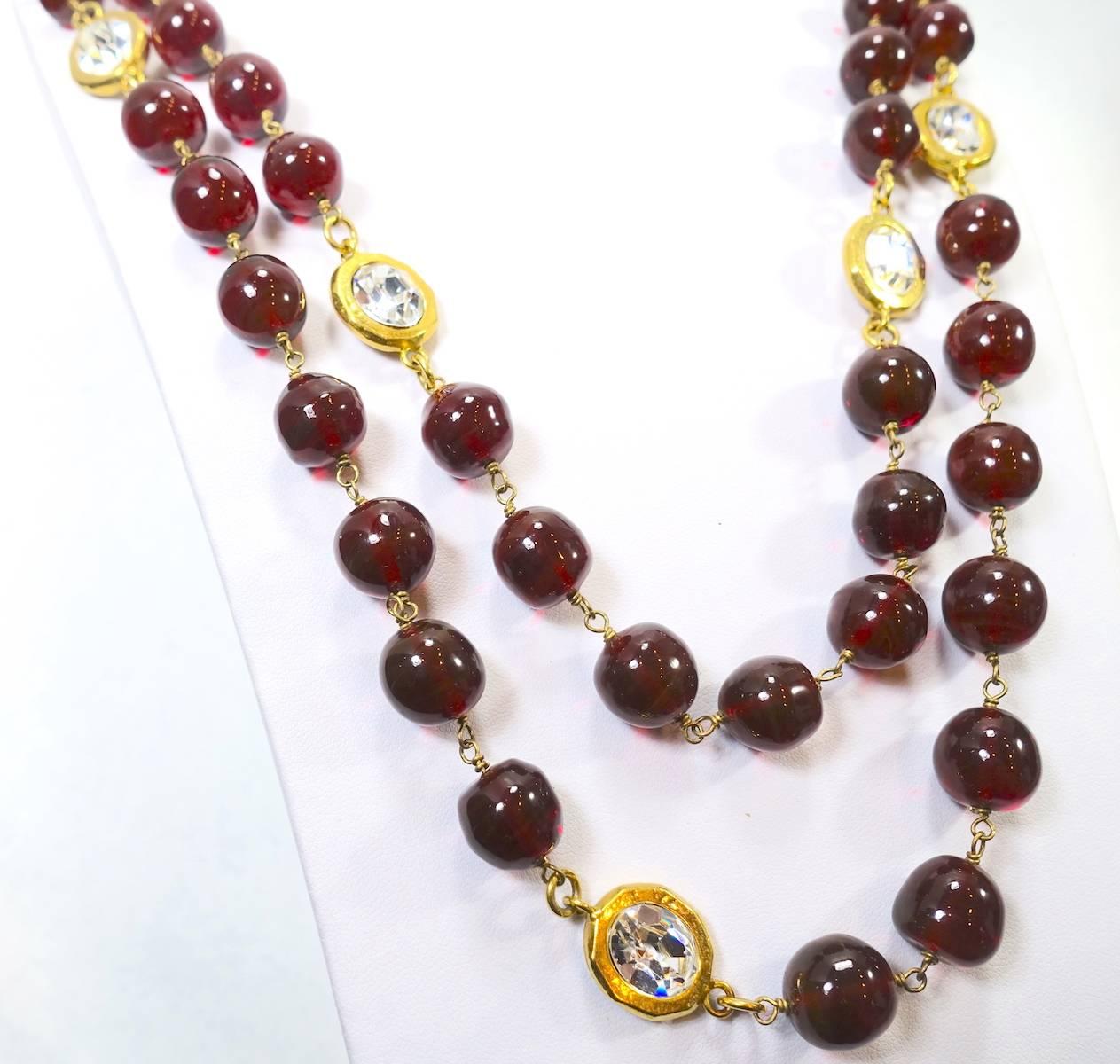 This vintage signed Chanel necklace features the famous cranberry Gripoix glass beads with crystal accents in a gold-tone setting.  This sautoir necklace measures 60” x 1/2”, is signed ‘Chanel Made in France” and is in excellent condition.