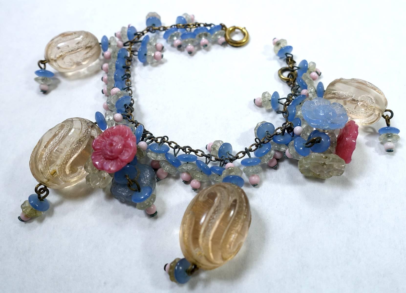 This very rare, early Miriam Haskell bracelet by Frank Hess is featured in Deanna Fernatti’s costume jewelry collector’s book (p.84).  This bracelet has glass beads in blue, pink and clear in a gold-tone setting.  It measures 7” long with a spring