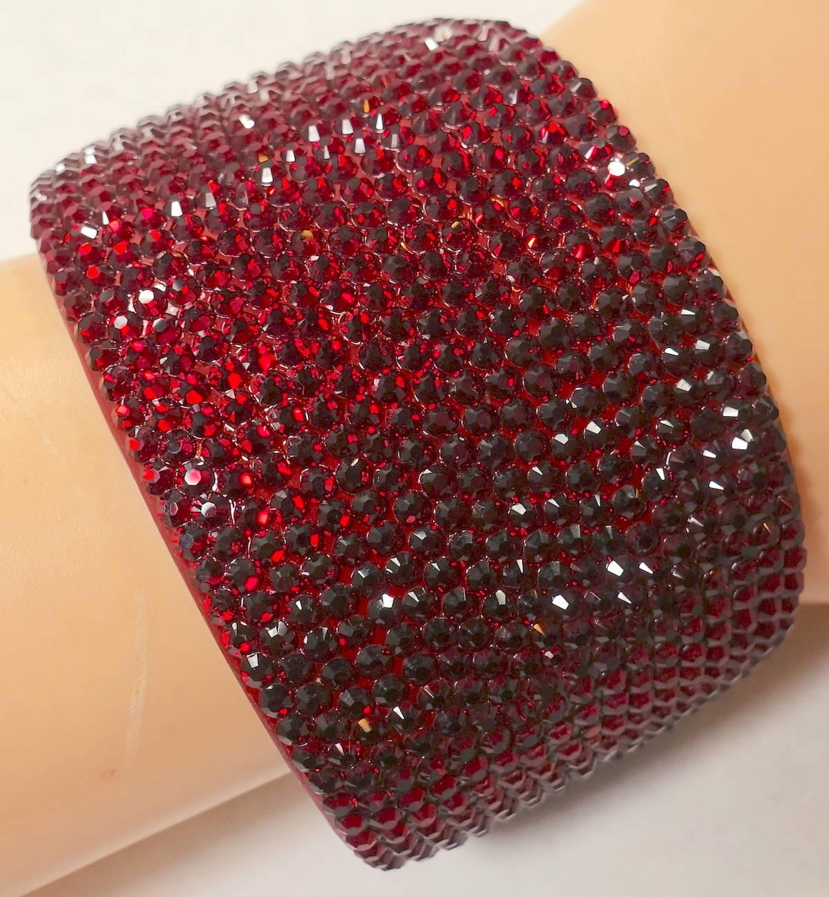 This Kenneth Jay Lane cuff is perfect for the holidays … actually any holiday. The entire cuff is embedded with tiny red rhinestones in a Japanned setting.  It is 1-7/8” high and 6-7/8” wide with a side spring opening.  It is signed “KJL” and in