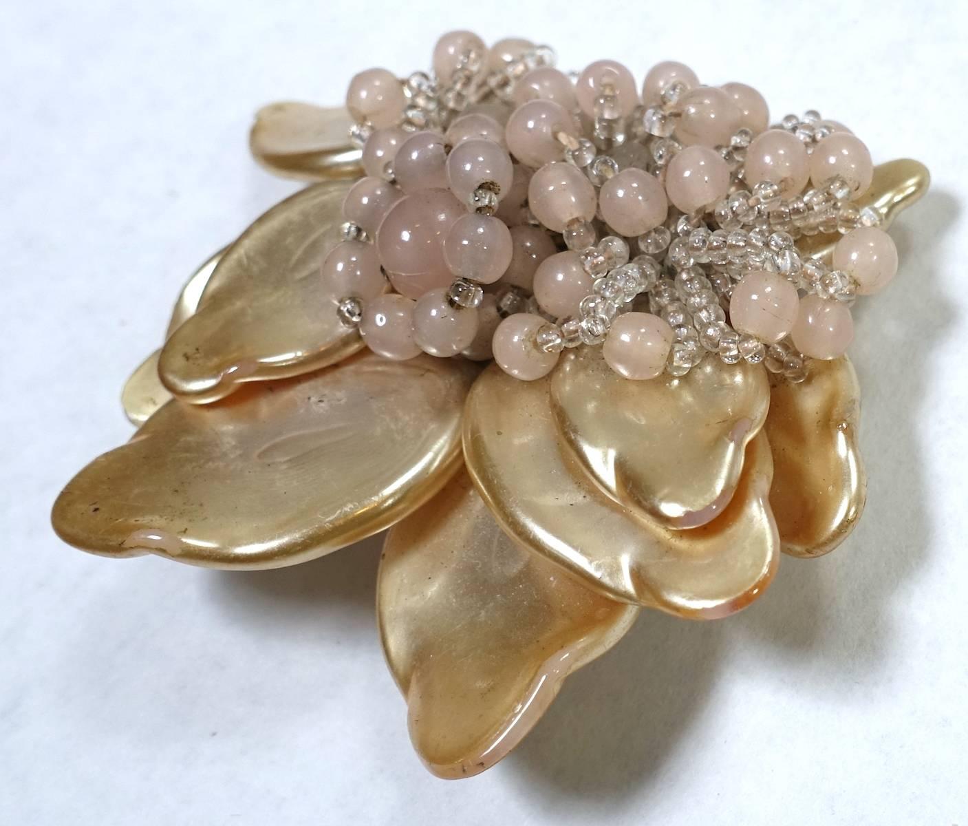 It is so rare to find an early Haskell fur clip.  It was made in the early 1930s before she put her signature on.  But you can tell from the style and back that this is Haskell.  It is designed with faux pearl leaves with pink glass bead accents in