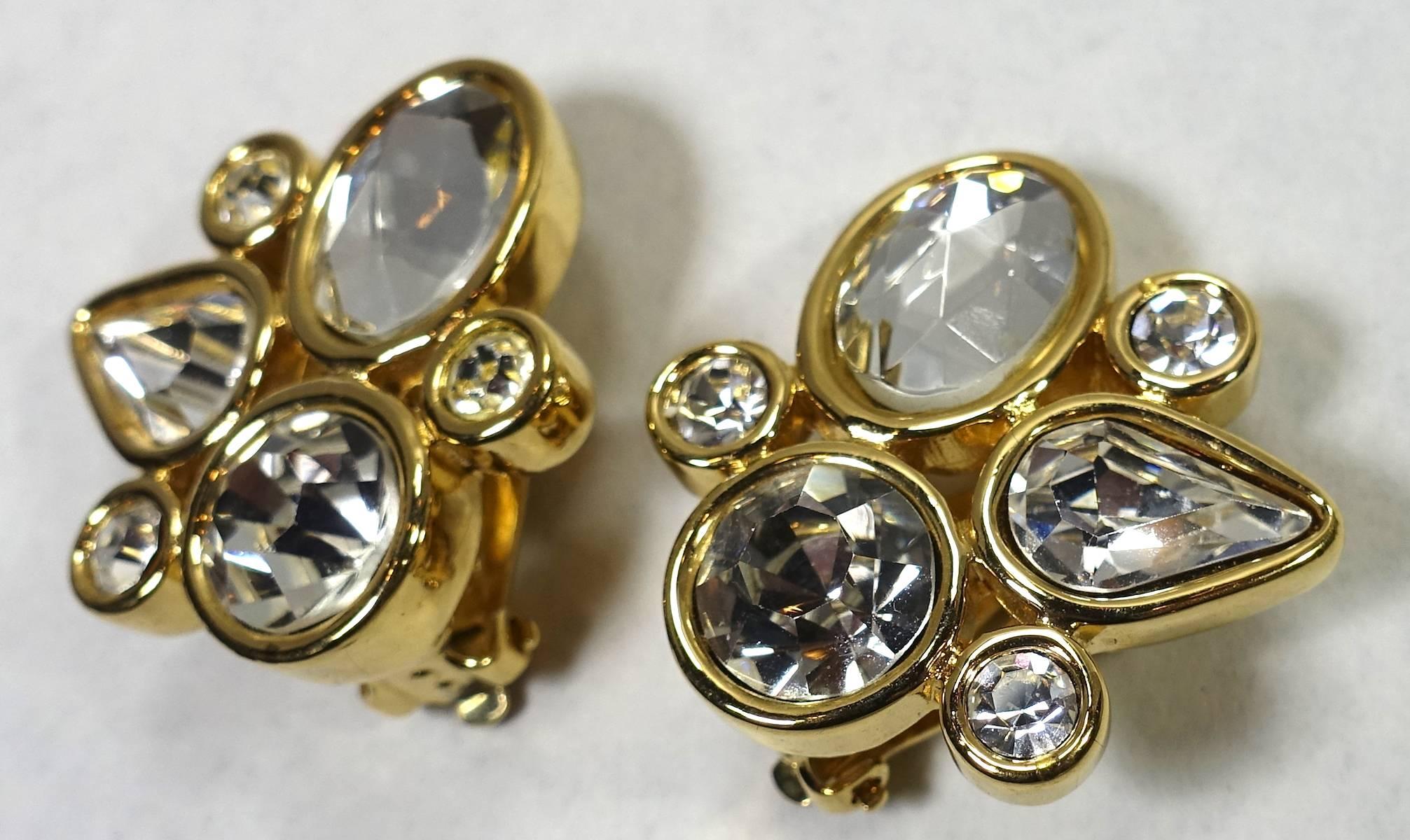 These vintage Givenchy earrings have an abstract design combining different shaped crystals bezel in a gold tone setting.  These clip earrings measure 1-1/8” x 1-1/8” and are signed “Givenchy”.  They are in excellent condition.