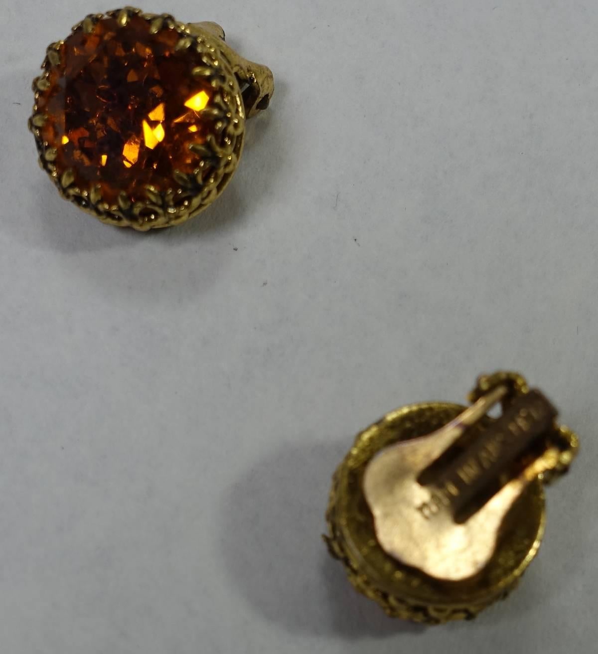 Austrian is known for their fine crystals and these earrings reflect that beauty. These vintage Austrian earrings feature topaz crystals in a gold tone setting.  These clip earrings measure 5/8” and are signed “MADE IN AUSTRIA”.  They are in