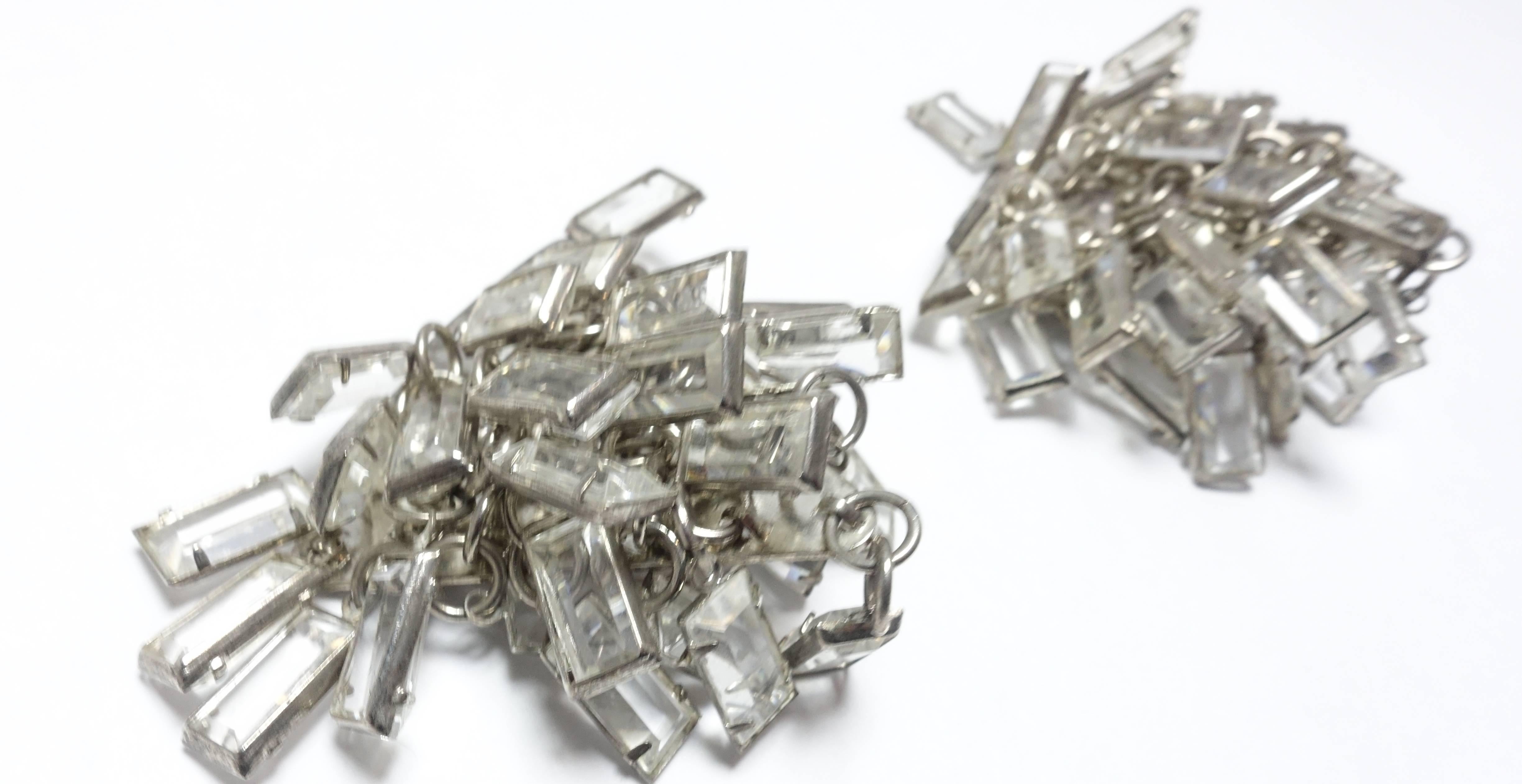 These gorgeous Sorrelli earrings are filled with cascading baguette stones and have a triangular back in a silver tone metal setting and most likely used on the runway.  The front has a multitude of rectangular (baguette) crystals dangling over each
