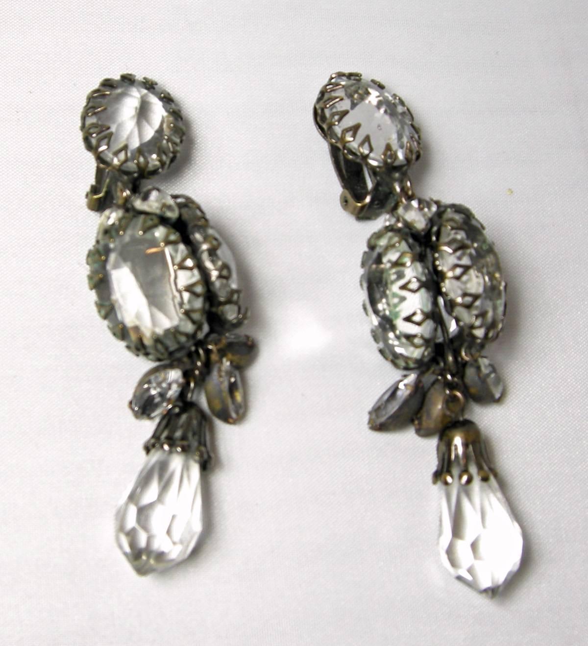 I fell in love with these long drop earrings.  The top has a large pronged oval crystal, which is connected to three tear-shaped crystals leading to three more oval crystals creating a 3-dimensional dome.  Three more crystals hang down to a capped