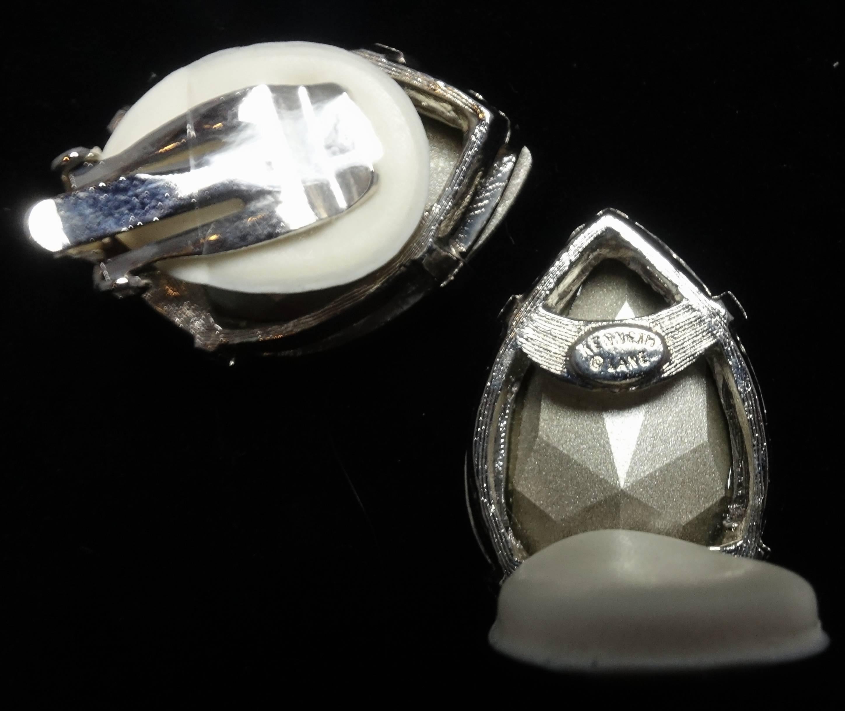 These Kenneth Jay Lane clip earrings feature a dazzling crystal teardrop in a silver tone setting.  The earrings measure 1-1/4” x 1” and are signed “Kenneth Lane”.  They are in excellent condition.