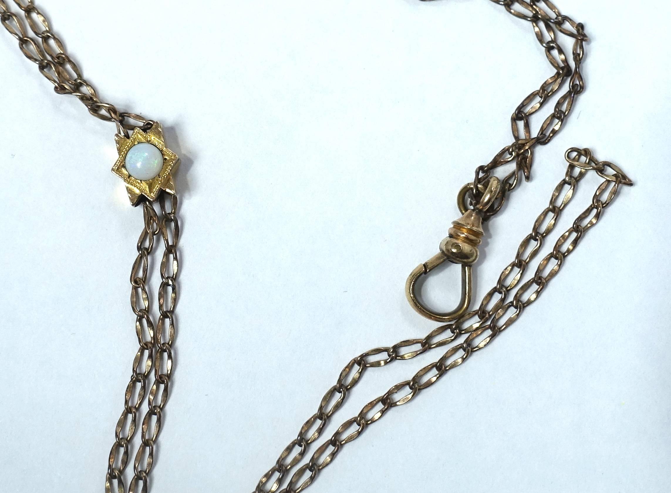 This Victorian 1800s gold filled watch FOB and chain can be worn as a necklace.  It features a slide with opal accents. It is signed “HHB & Co.”  The necklace measures 25” long and the slide is 3/8” x 1/4”.  It is in excellent condition.