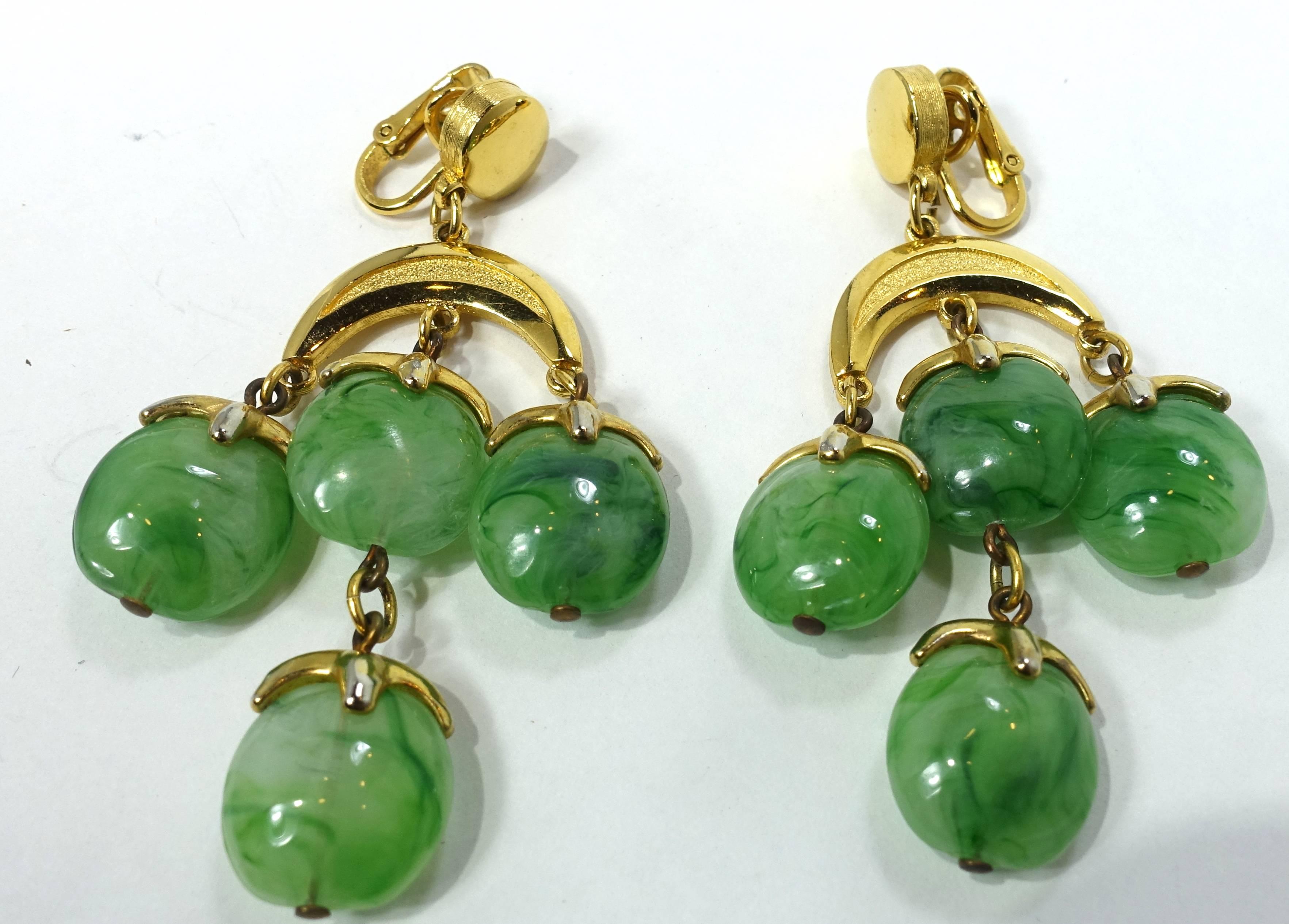 These vintage signed Trifari earrings have green marbled glass drops in a gold tone setting.  These clip earrings measure 3” x 1-1/2” and are signed “Trifari”. They are in excellent condition.