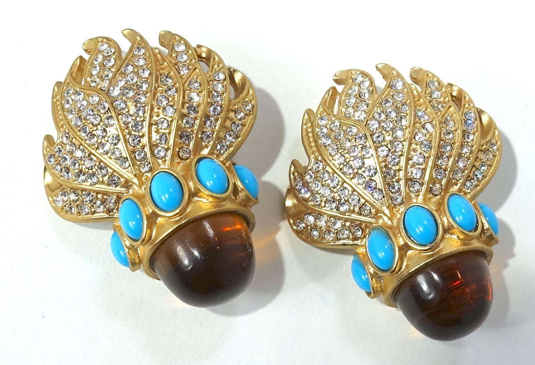 These vintage 1960’s earrings have a large faux topaz bullet shape with turquoise and rhinestone accents in a gold tone setting.  The earrings are glitzy but we toned down the photo so you could see the details.  These clip earrings measure 1-3/4” x