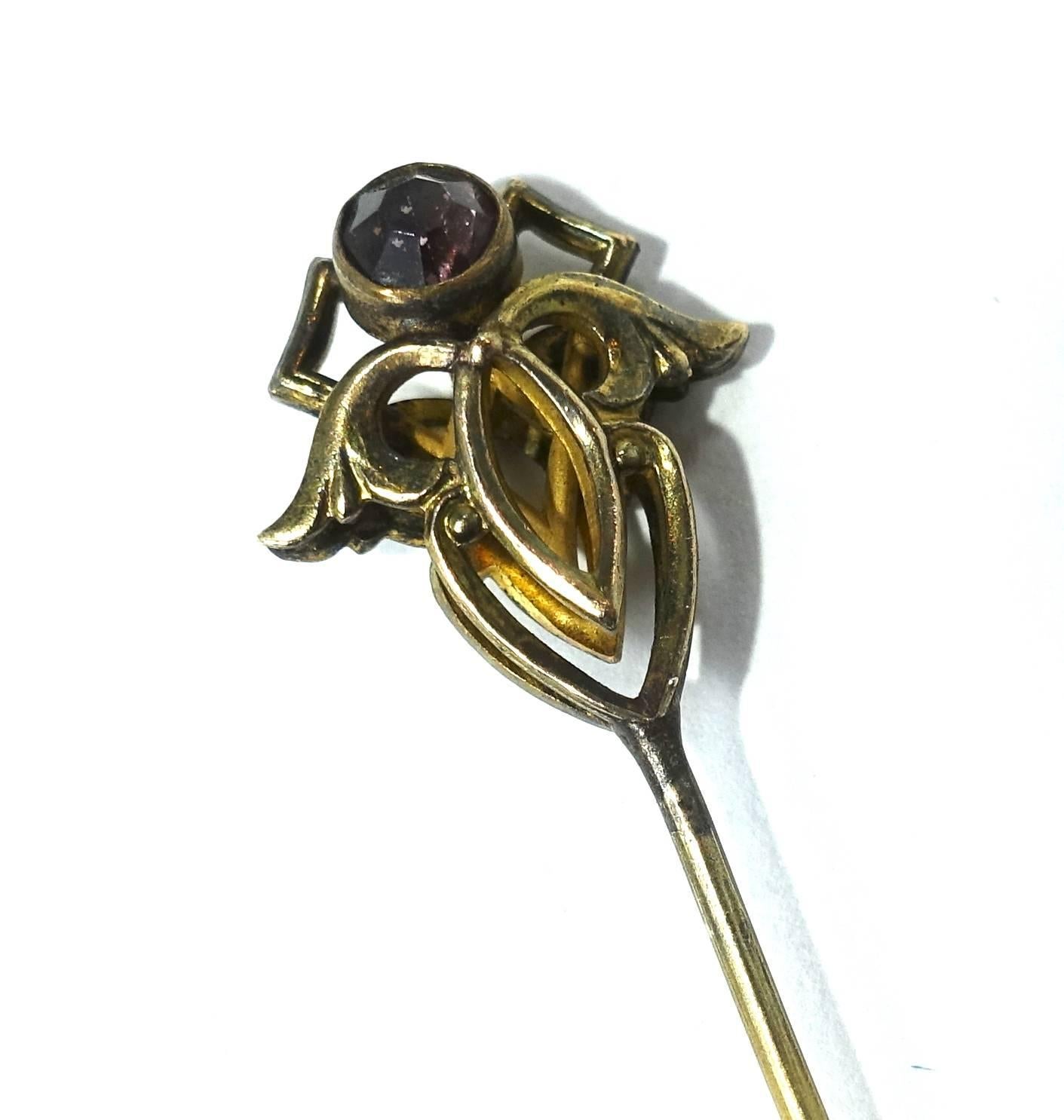 This early 1900s vintage stick-pin features an amethyst stone in a gold tone setting.  In excellent condition, this pin measures 3-1/8” long and 1/2” on the top.