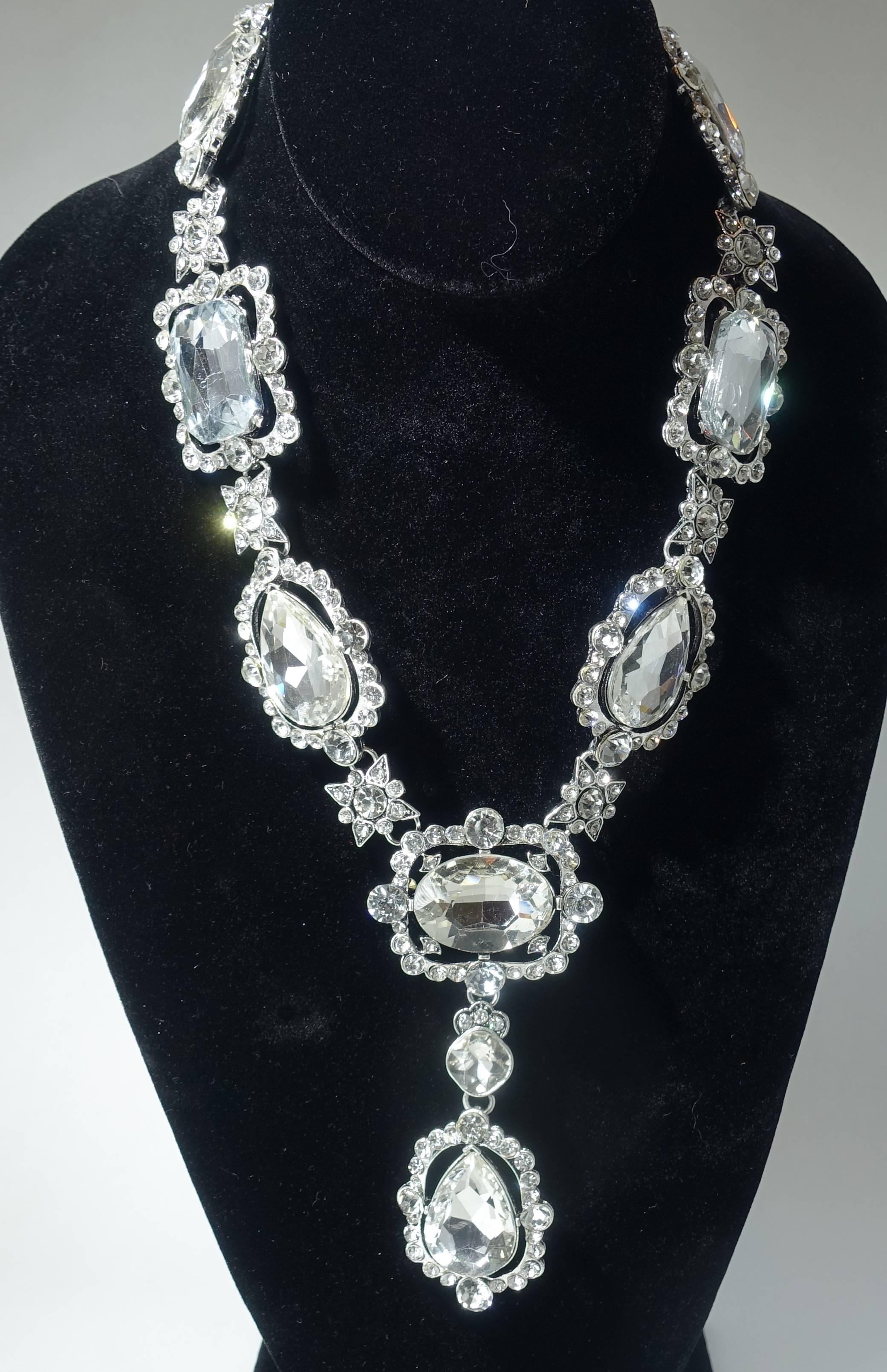 This Oscar de la Renta necklace is perfect for a wedding or any other celebration. This glitzy necklace has clear crystals in a silver tone setting.  This necklace measures 19” long with a spring closure x 1-1/4” and the front drop is 4-1/4” top to
