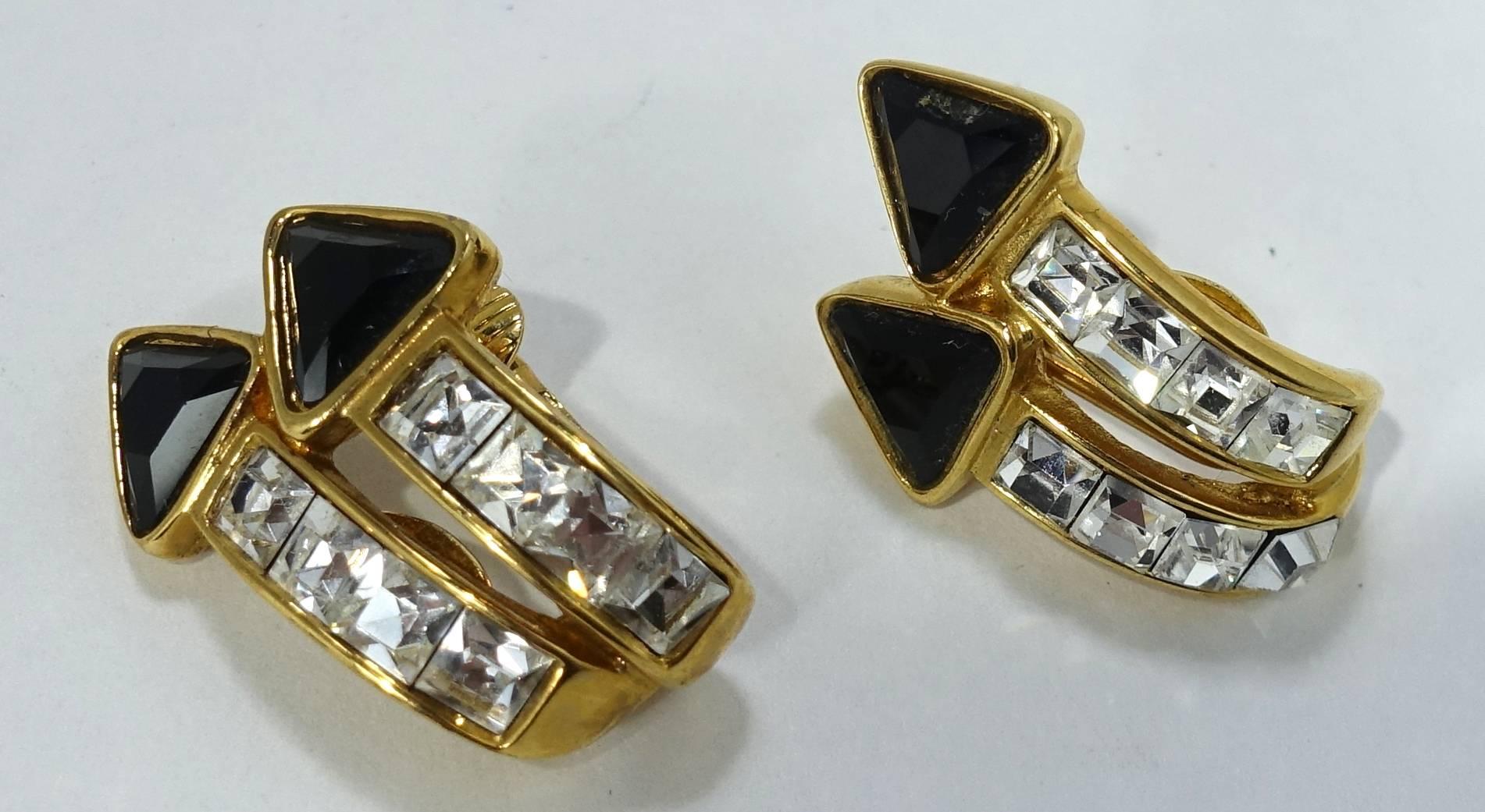 These Kenneth Jay Lane earrings are designed with two arrows pointing upward.  They have black and clear rhinestones in a goldtone setting.  These clip earrings measure 1-1/4” x 3/4” and are signed “Kenneth Lane”. They are in excellent condition.