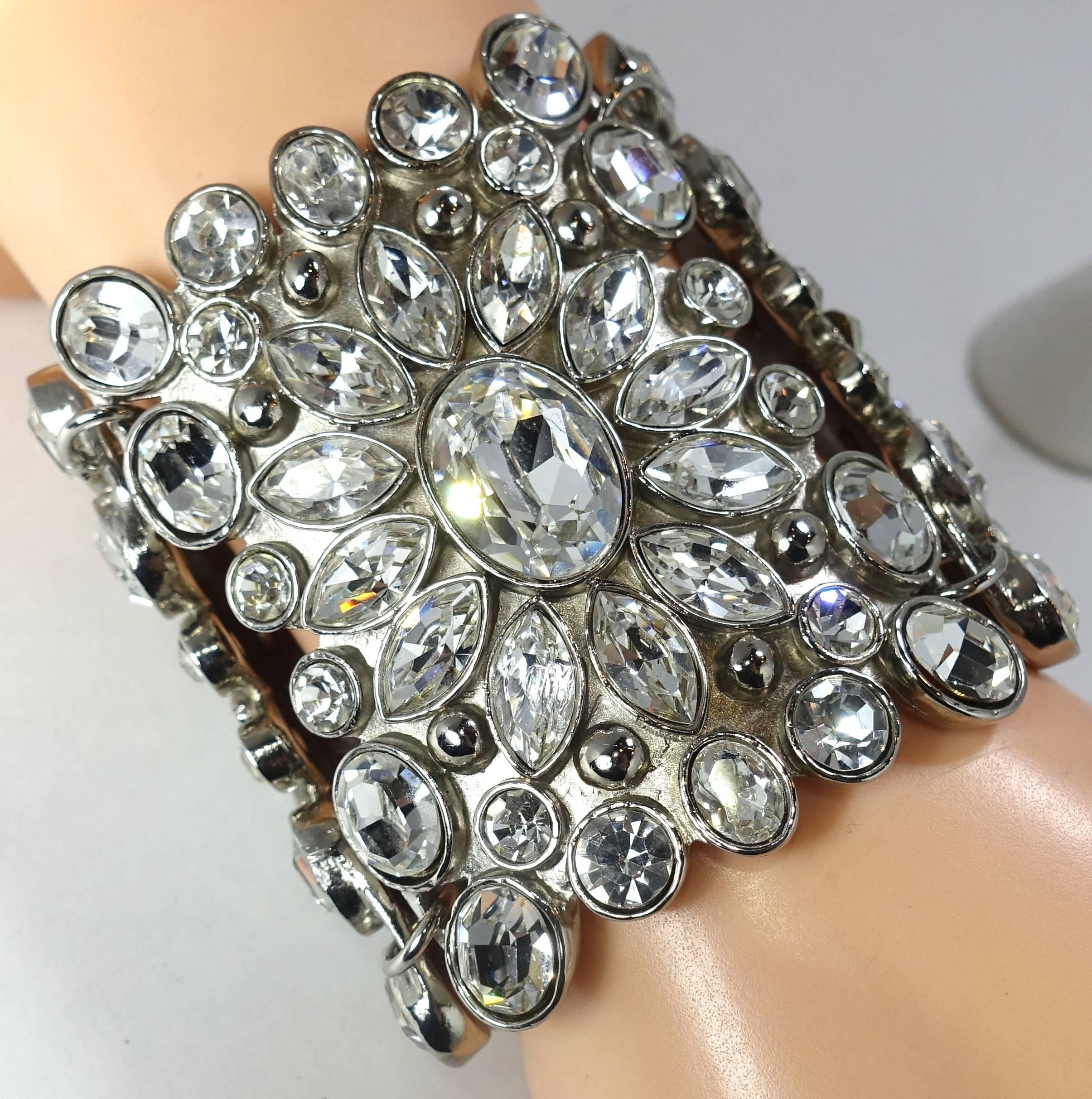 This bracelet by Kenneth Jay Lane is a prototype, which means this is the only one. It is certainly an eye catcher on the wrist.  It is made in 3 large sections with a huge oval crystal in the center of each section.  They are surrounded with
