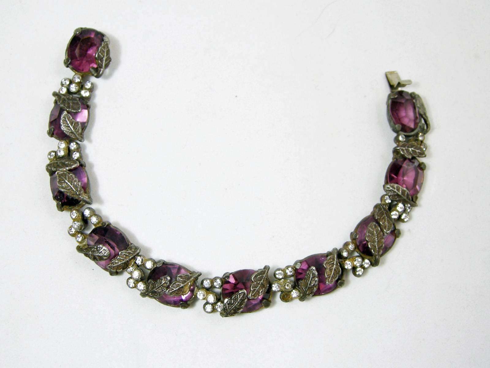 I go crazy over bracelets like this.  It’s the old Czech faux amethyst crystal decorated with antique silver tone leaves.  Each link is separated with rhinestones.  It has a slide in catch and measures 7-1/2” long x 1/2