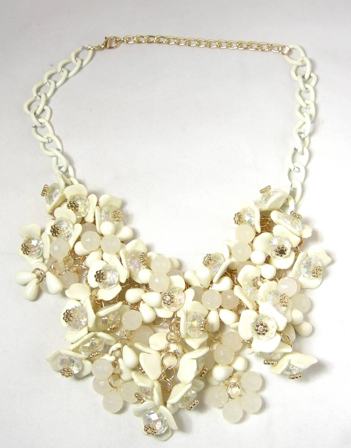 I love jewelry that you can wear anywhere … at any time.  This bib necklace has rows and rows of faux ivory flowers with Aurora Borealis centers with tiny gold tone flowers.  The bib is connected to a gold tone mesh backing with a white enamel open