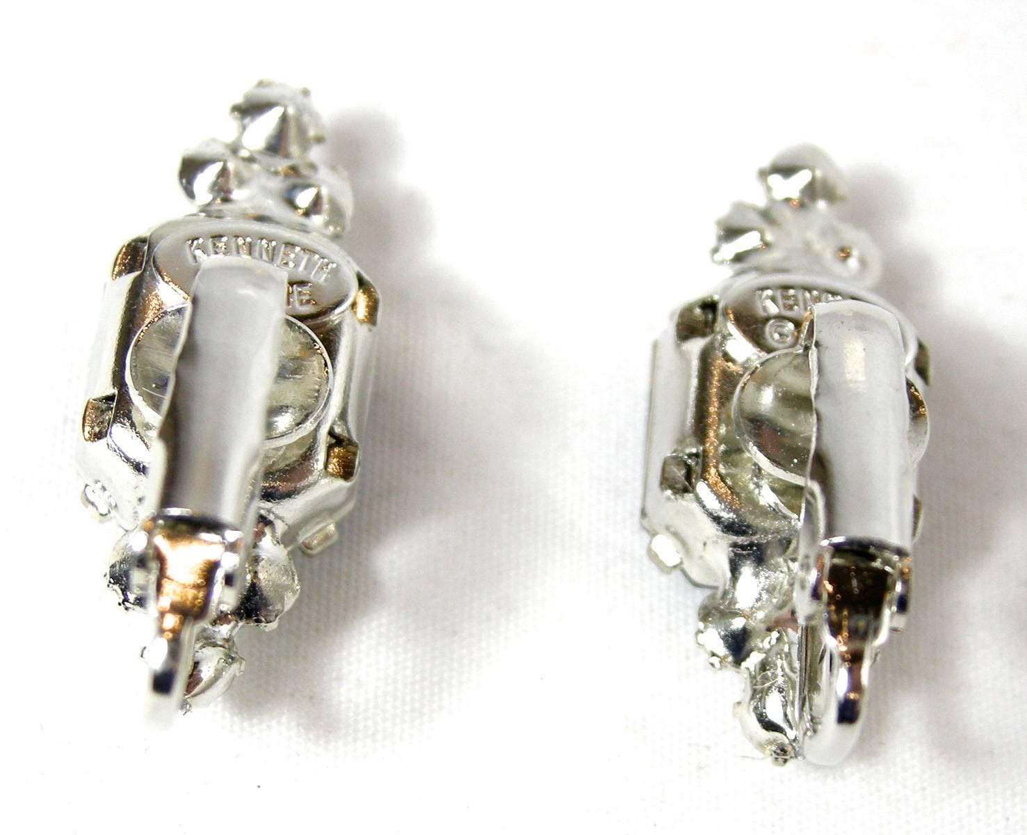 These clip earrings by Kenneth Jay Lane look almost real.  Although they are petite in size, the faux sapphires are prong set in a silver tone metal finish.  Three tiny rhinestones compliment the top and the bottom making these earrings look