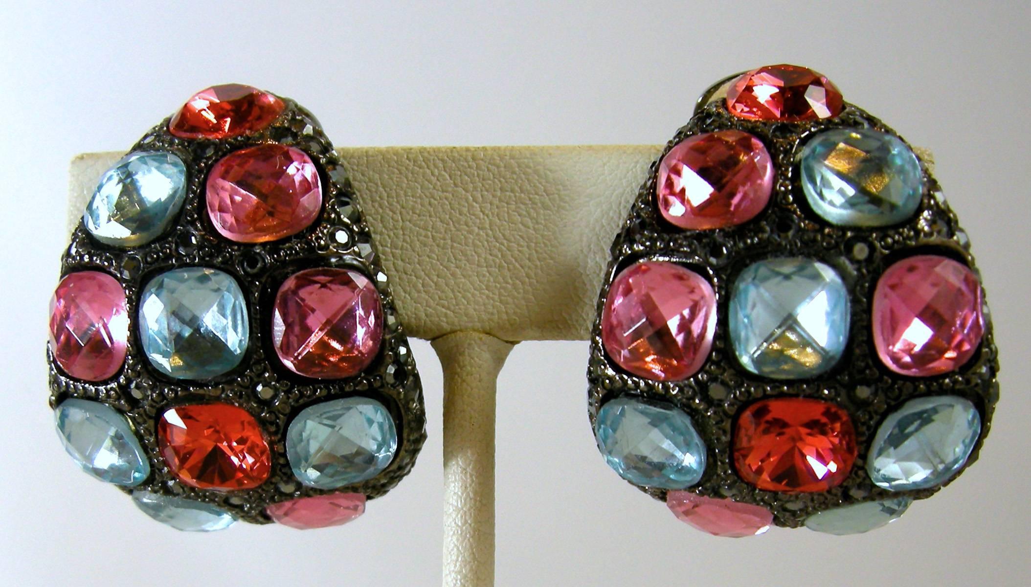 Spring and summer is just around the corner and what better way to show off with these stunning Kenneth Jay Lane earrings. It has a dome shape with large blue, pink and burnt crimson rhinestones surrounding by black rhinestones.  They measure 2-5/8”