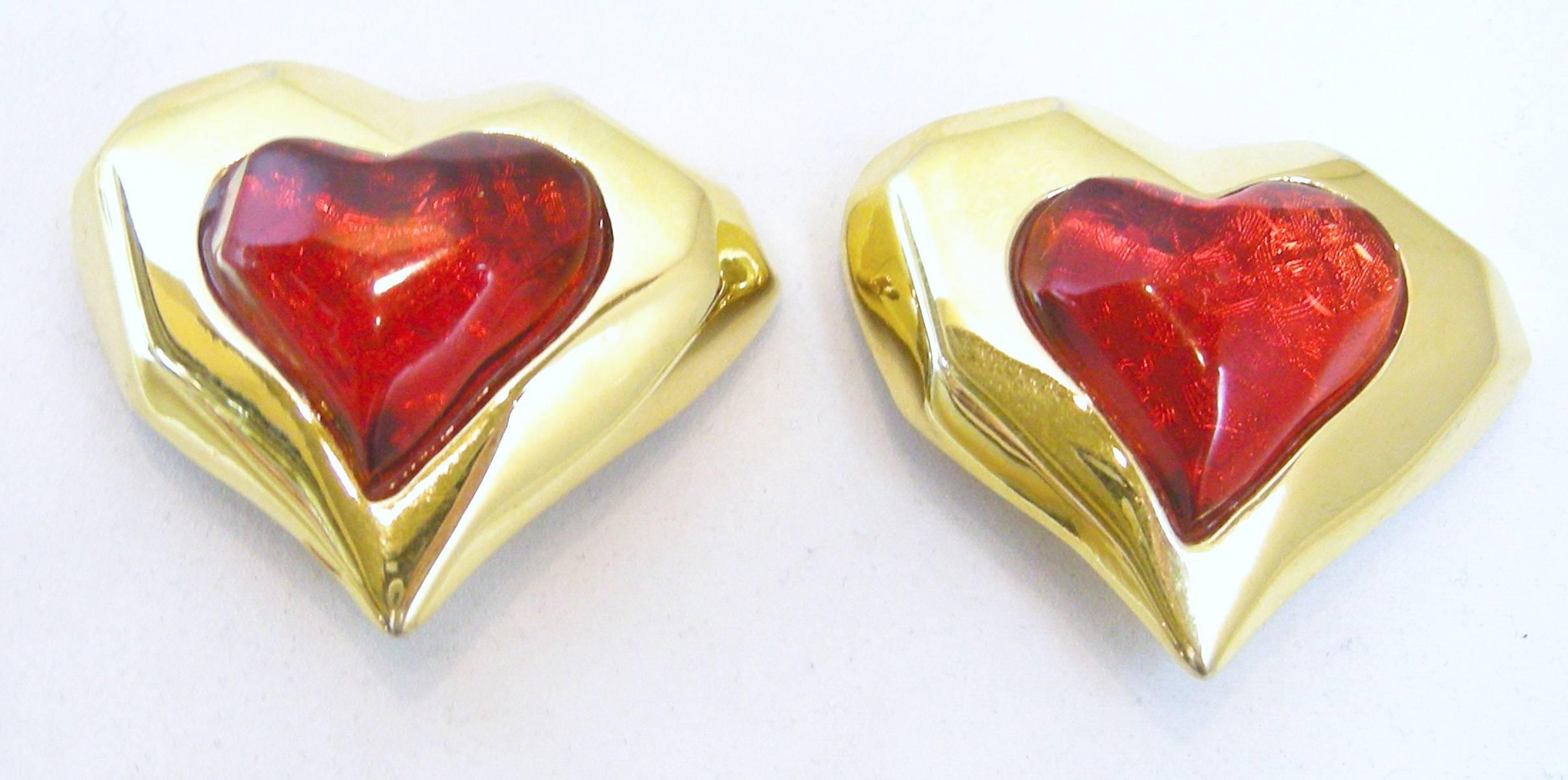 These vintage heart shaped clip earrings have a heart shaped gold tone border with a red heart stone in the center.  The earrings measure 1-1/2” long x 2” wide.  Although they do not have a signature, they are signed “Made in U.S.A”.  They are in