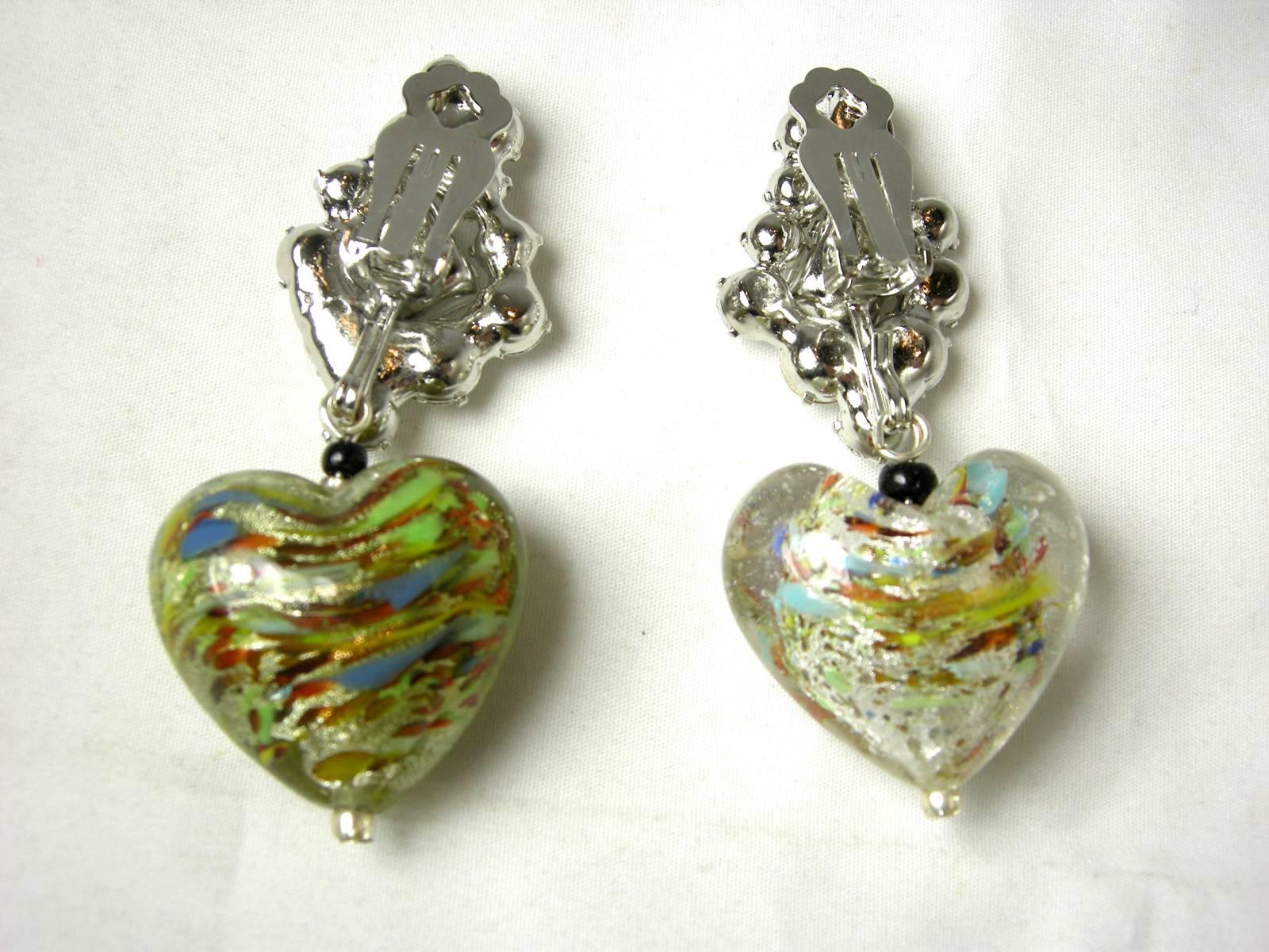 These wonderful heart shaped clip earrings by Robert Sorrell are lovely.  They have a rhinestone cluster that extends down to hand blown multi-color heart shaped glass drops.  Each heart is slightly different since each one is hand blown. They