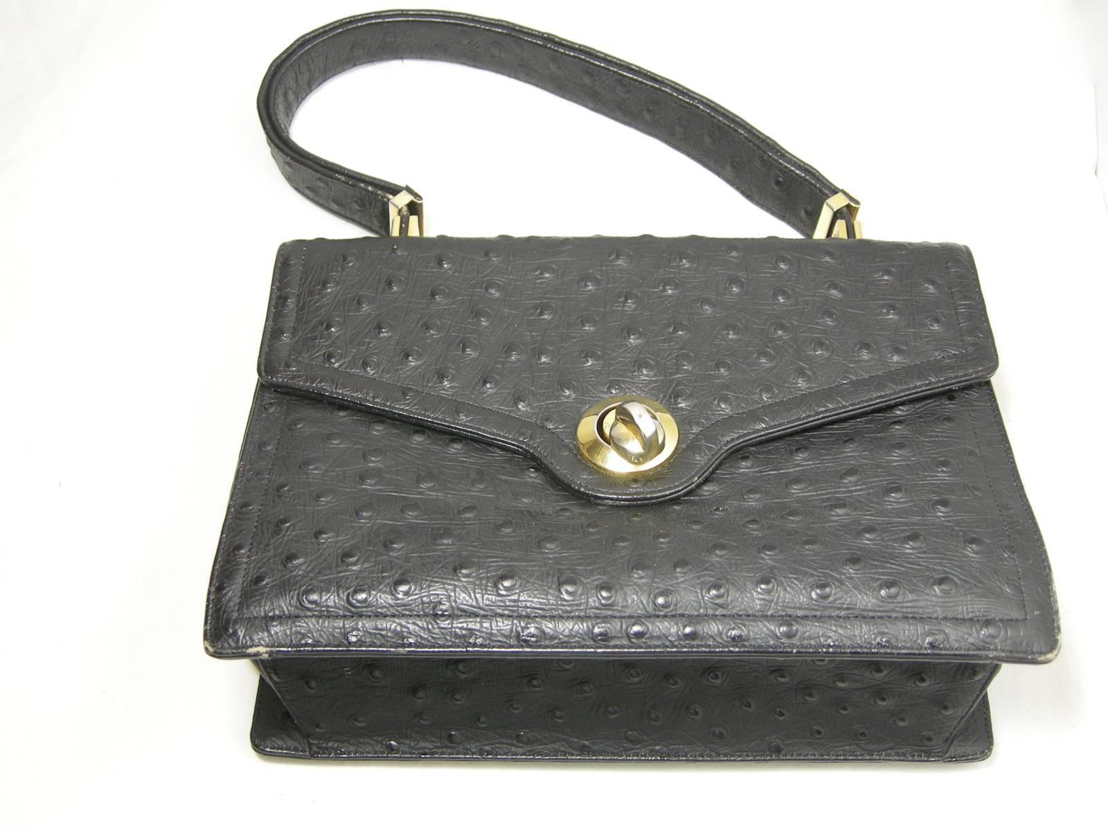 This vintage Koret genuine full quill ostrich black leather handbag has  gold tone hardware and it opens with an easy twist. The inside is made of  beautiful black leather with the original  black coin purse. The bag has a zipper compartment across