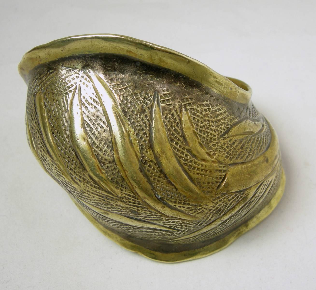 This is a very unusual cuff bracelet made of a bronze metal.  It has a solid mesh design with long solid rods designed throughout.  It is not your normal cuff, which is why I love it.  It is 3” wide at its larges point and 7” circumference.  It’s in