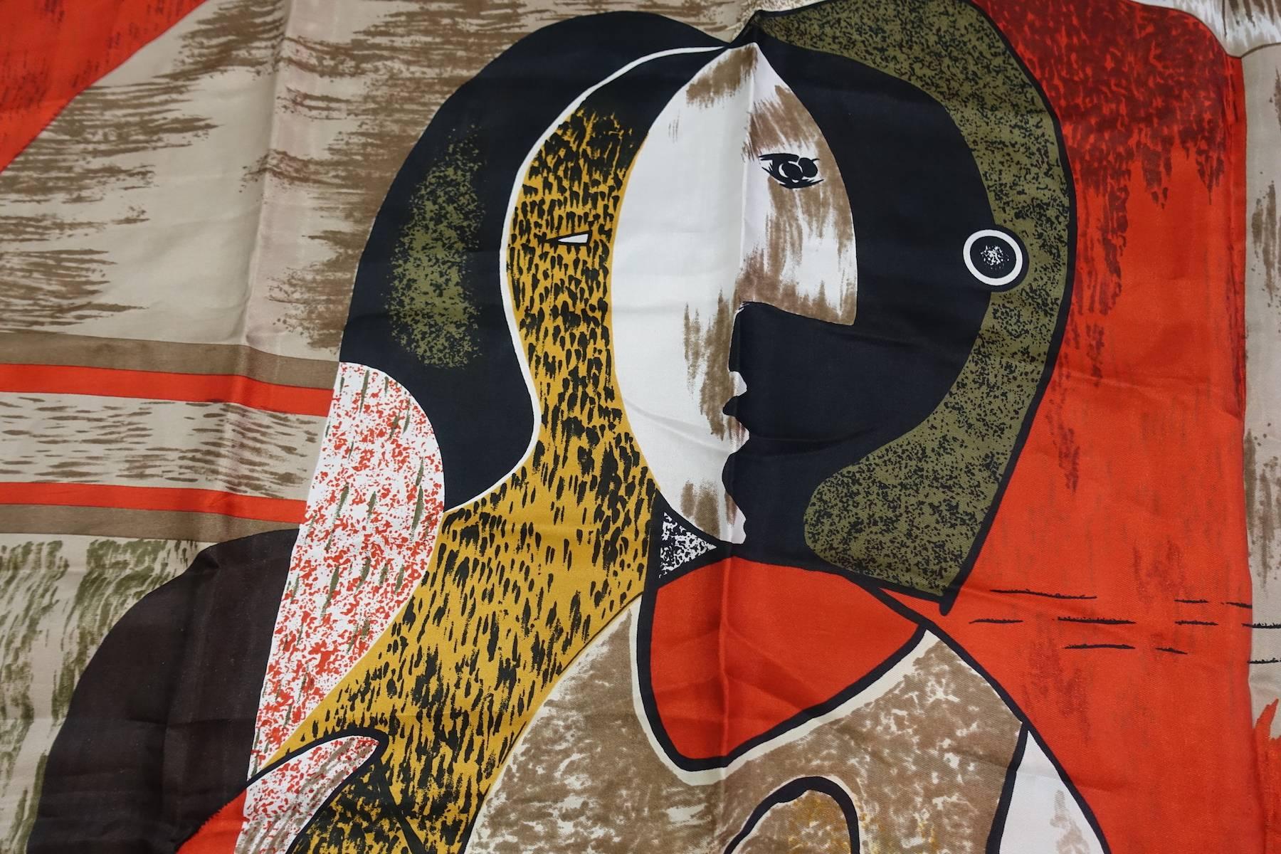 This vintage signed Picasso scarf features an abstract design in shades of brown, gold, orange and beige.  This scarf measures 35” x 35” and is in excellent condition.