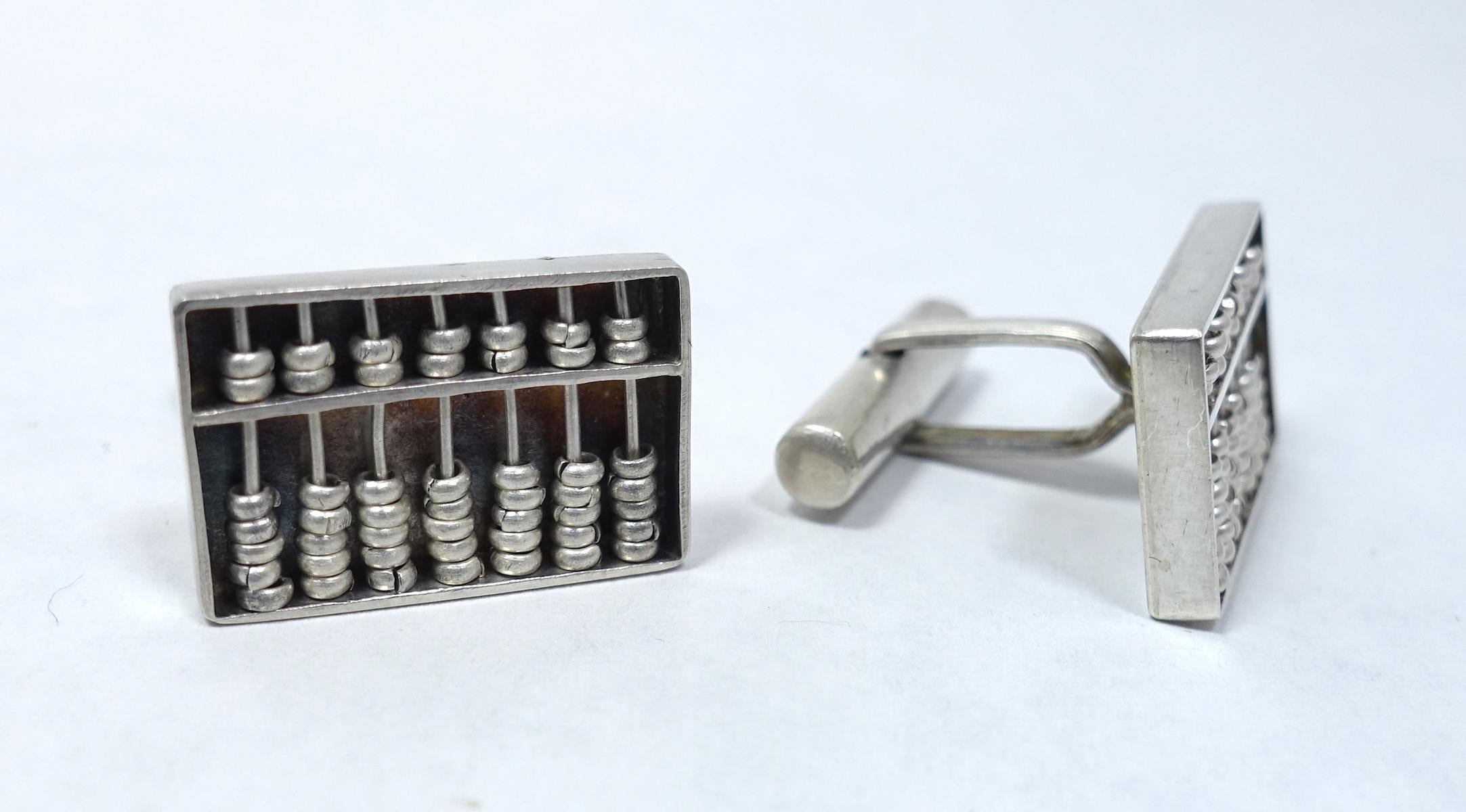 These sterling silver cufflinks feature an abacus design.  In excellent condition, they measures 3/4” x 1/2”.