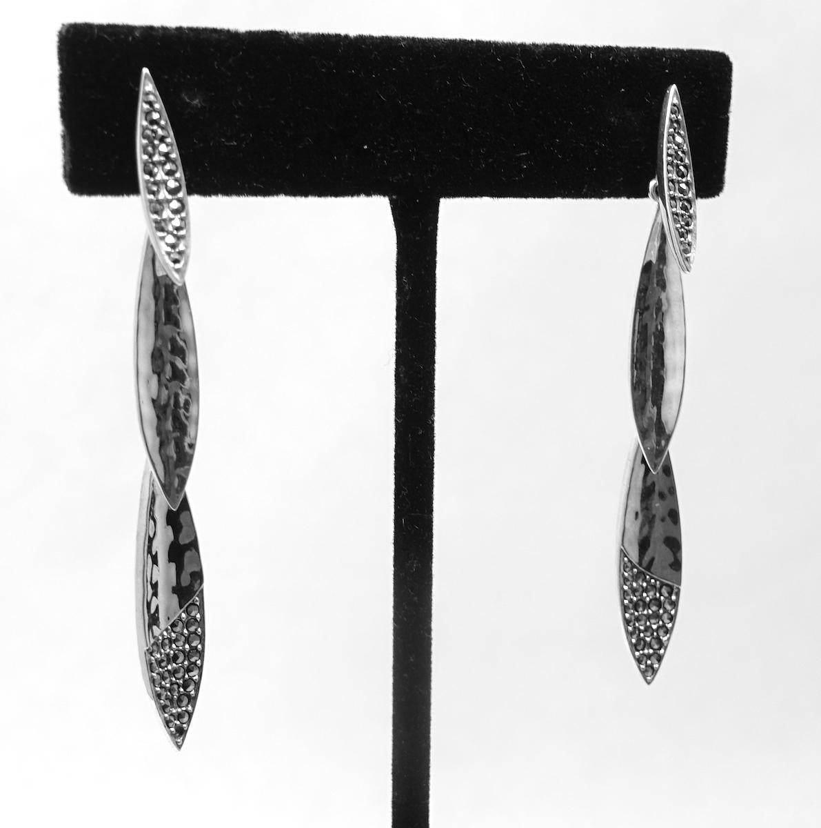 These vintage drop earrings feature marcasites in a sterling silver setting.  These pierced earrings measure 2-3/8” x ¼” and are in excellent condition.
