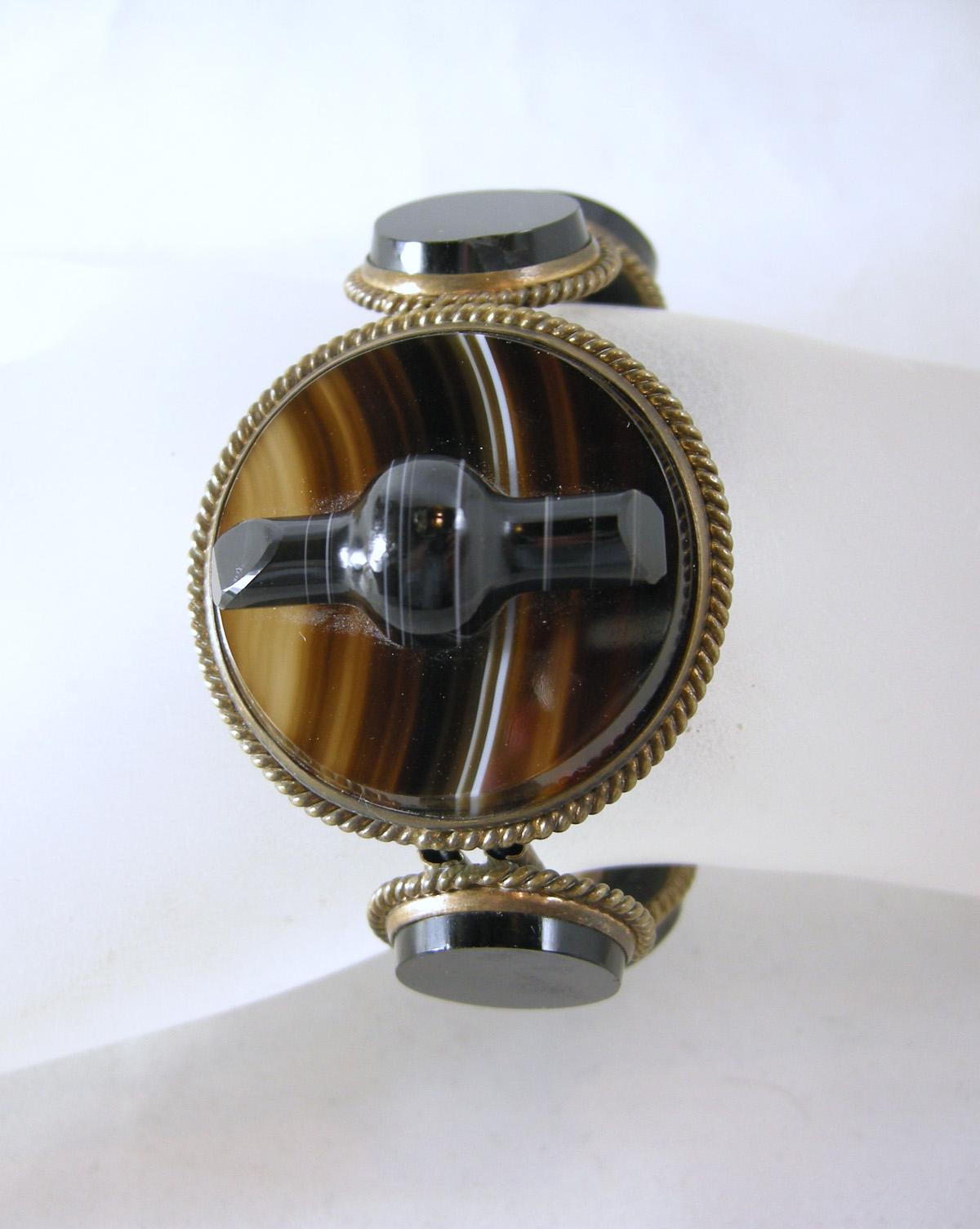 This is an exceptional Victorian Scottish banded agate bracelet and pin set.  The bracelet is a stretch bracelet in brown agate with a banded agate center.  It is sterling silver with a gold wash.  The bracelet will fit a size 6 to 7.  The front