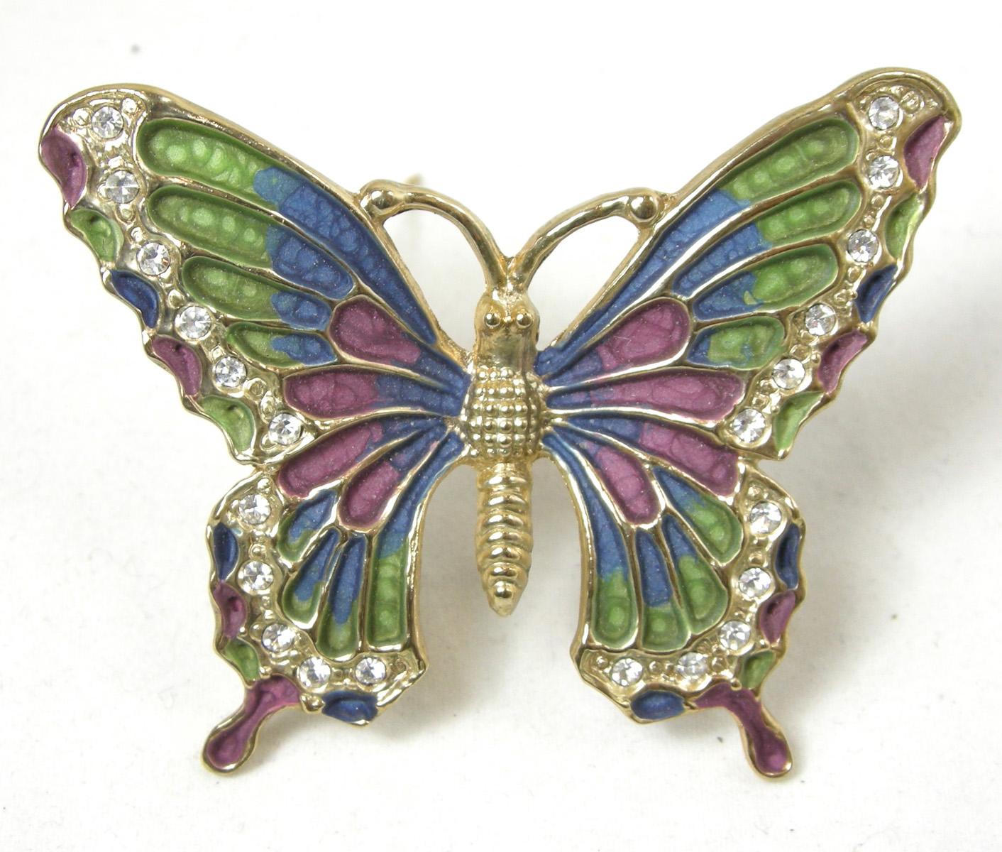 This is a beautiful butterfly pin with colorful wings of green and mauve and accented with rhinestones throughout the outer part of the wings.  It measures 2-1/4” wide x 2” long in a gold tone setting.  It is in excellent condition.