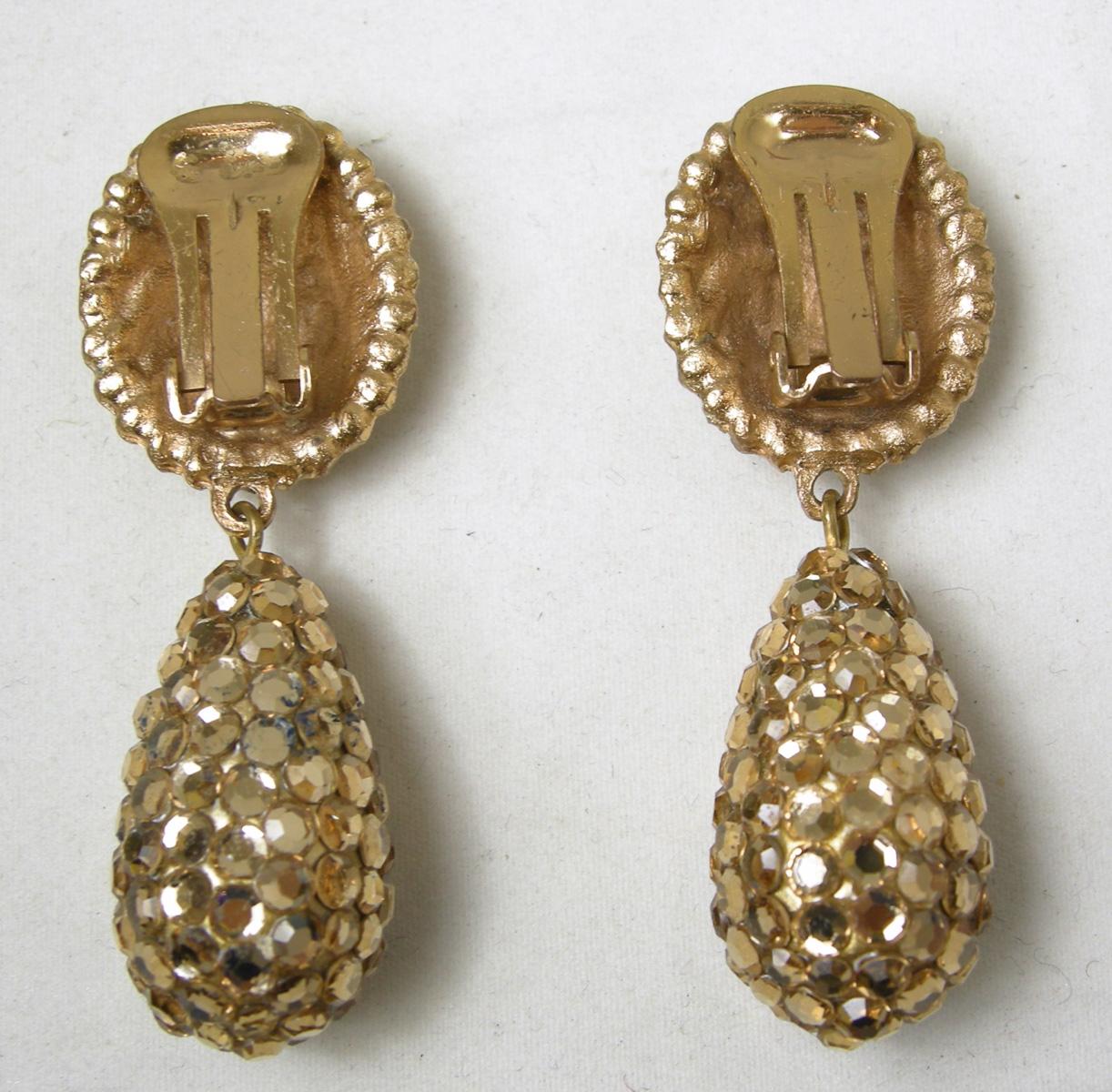 When I first saw these clip earrings, I thought they were made by Richard Kerr.  It has the flat back gold tone rhinestones he was famous for.  These clip earrings have a round disk top with a large dangling drop.  It measures 2-1/4” long x 7/8”