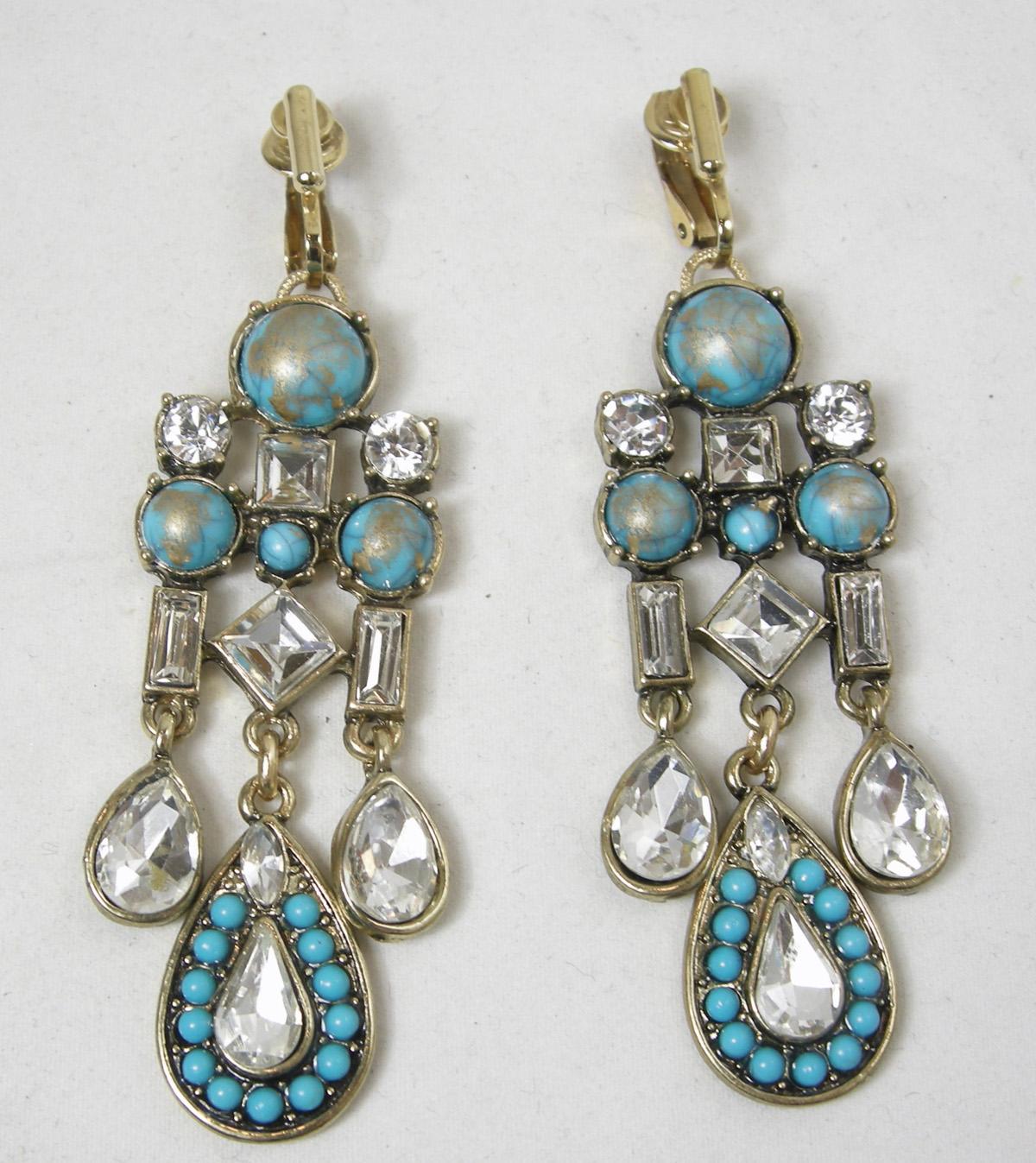 These vintage faux turquoise dangling earrings have a mixture of turquoise and gold enamel top with rhinestone accents.  Rhinestone baguettes hang from the sides with a teardrop rhinestone at the bottom.  The center has a tear drop shape with small