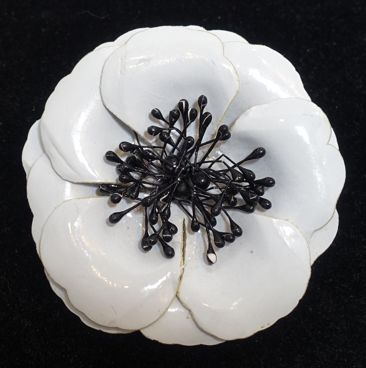 This vintage Anne Fontaine Italy round brooch features a floral design in black & white. It comes with the original square cardboard back signed “Anne Fontaine” which is removable.  This brooch measures 3-1/2” in diameter with a turn closure and is