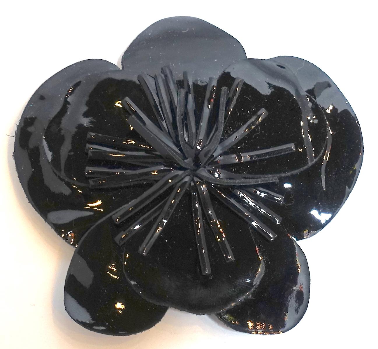 This vintage signed Anne Fontaine Italy brooch features a floral design in black vinyl.  This brooch measures 3-1/2” in diameter and is signed “Anne Fontaine – Made in Italy”.  It is in excellent condition.