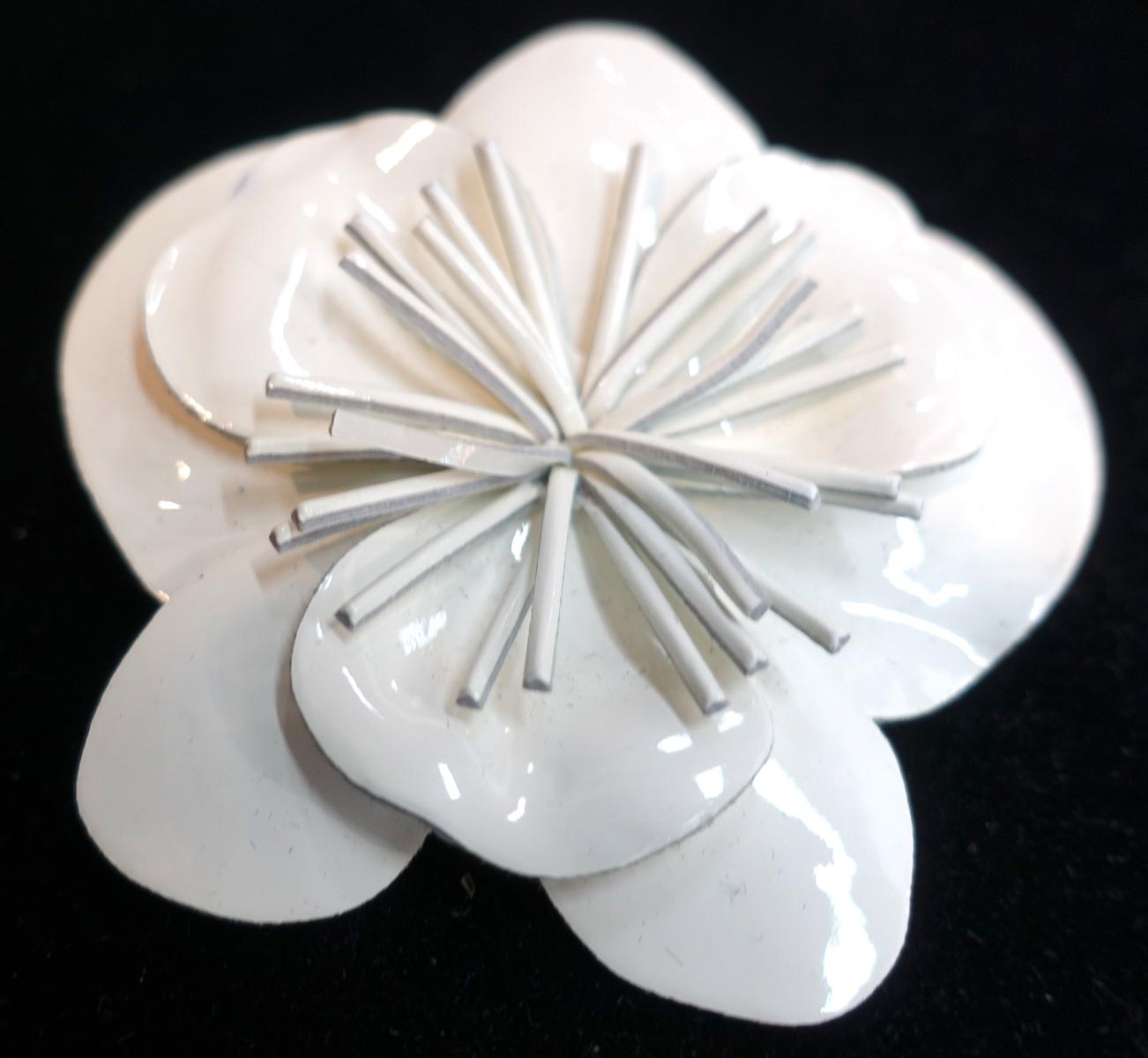 This vintage signed Anne Fontaine Italy brooch features a floral design in white vinyl.  This brooch measures 3-1/2” in diameter and is signed “Anne Fontaine – Made in Italy”.  It is in excellent condition.