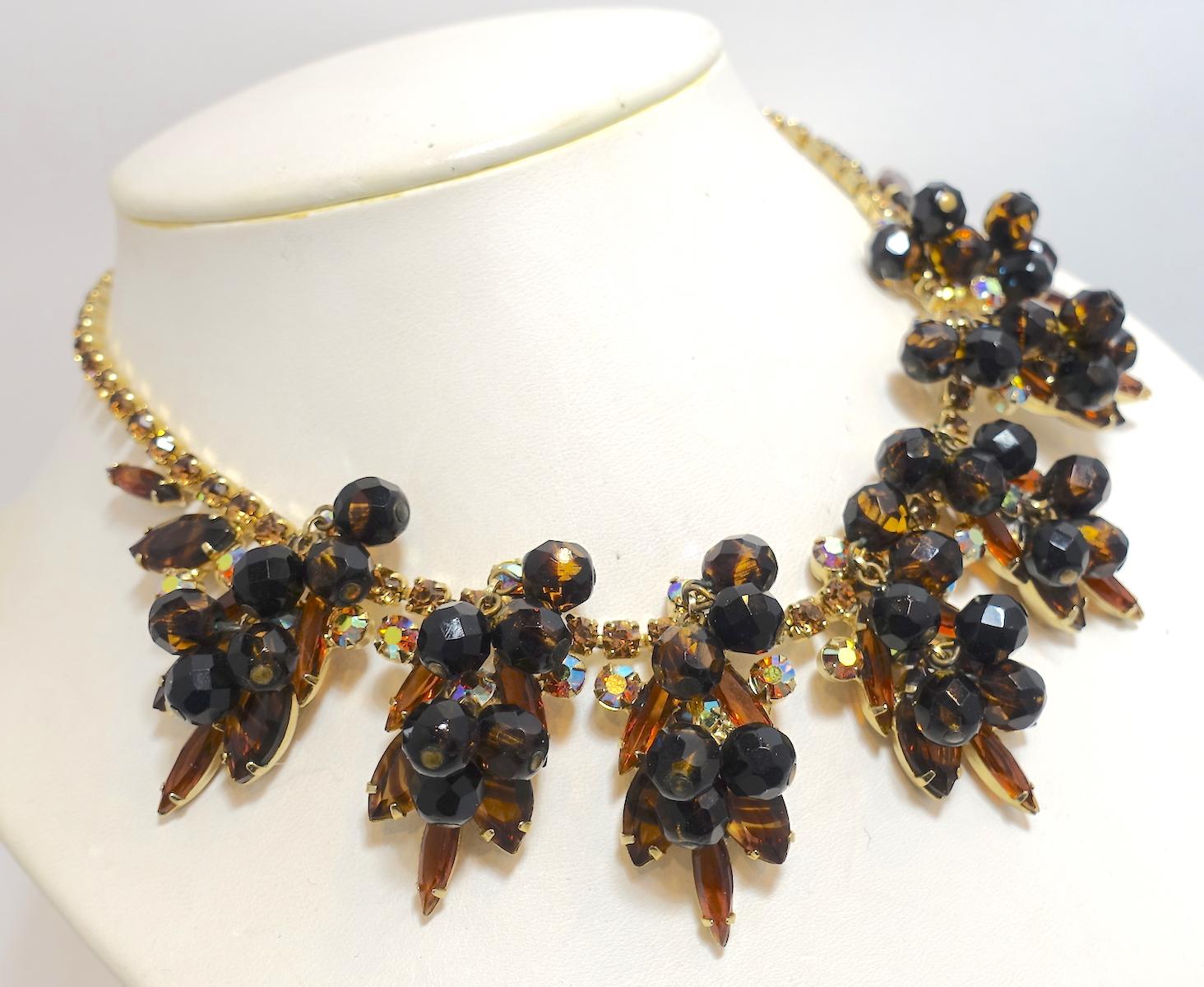When I first saw this necklace, I thought it might be a Juliana. This vintage necklace features 6 topaz color rhinestones and marbleized bead accent drops in a gold tone setting. The necklace measures 15-1/2” and the drops are 2-1/8” with a hook